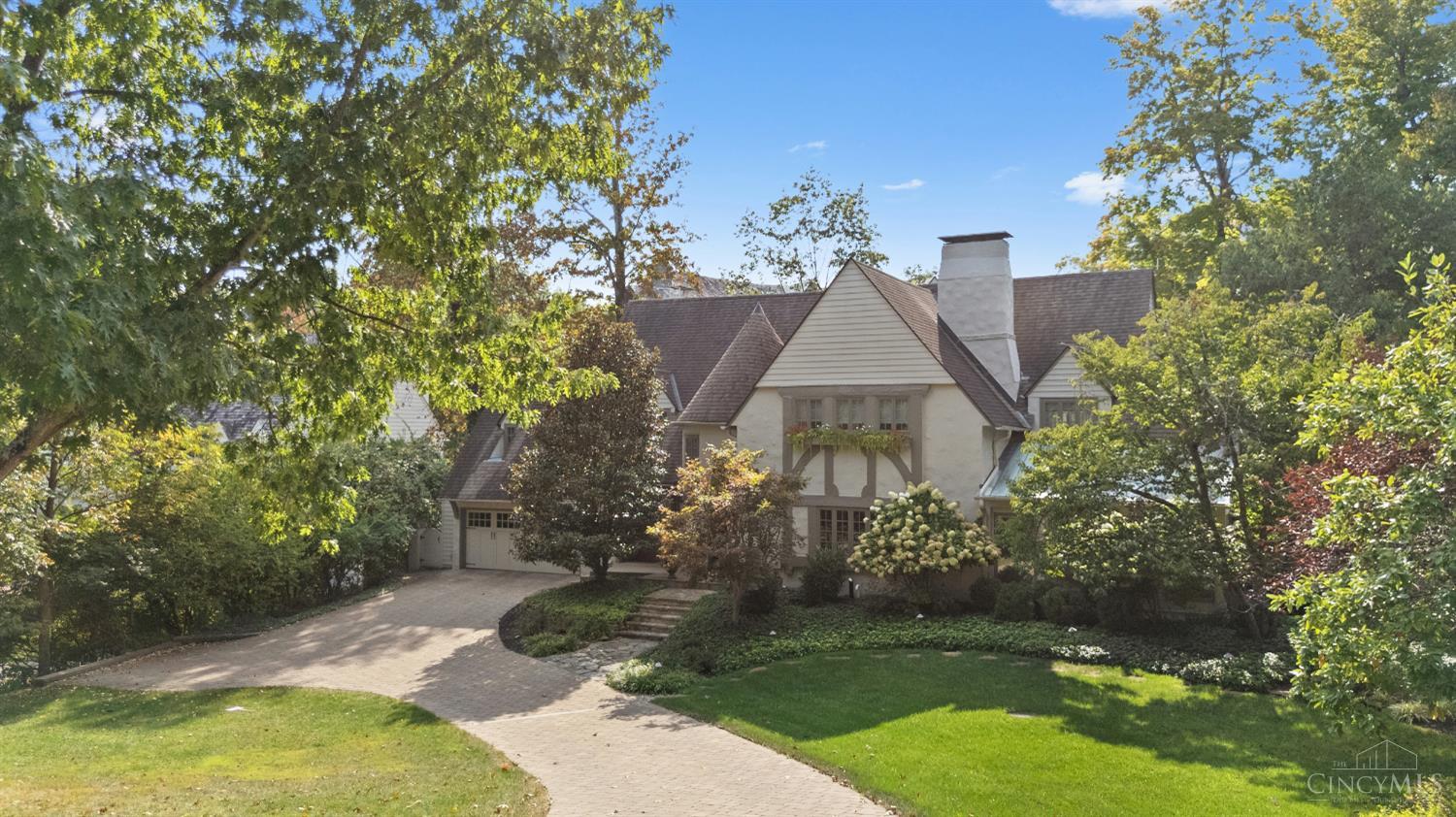 Stunning Storybook Tudor with 5,000+ sq ft of elegance & updates. The grand entry features iron staircase, the Great room features vaulted ceilings, skylights & walkout. The gourmet kitchen offers Sub Zero appliances, new coffee area & counter bar. Entertain in the Living, Great or Dining room flowing seamlessly to outdoor spaces with multiple walkouts. The 1st floor offers 2 studies, custom cabinetry, shelving & custom built in wine cellar. The newly designed LL includes fitness room, game area, entertainment room, wet bar & more. Enjoy 5 fireplaces & the redesigned entry from attached garage. 2nd level has a lovely layout with spa like ensuite & abundant storage including additional space on 3rd level. Lovely outdoor living, private patio, stone fire pit, grill with gas line, tiered landscaping & storage shed. This prime East Rookwood address provides a lifestyle of distinction surrounded by mature tree lined streets, & easy access to Hyde Park, shops, restaurants & more.