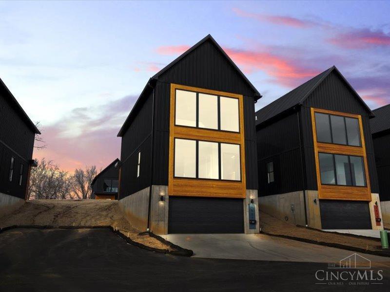 New construction and modern living in the Heart of Cincinnati. Built by Renowned Architect Jose Garcia. Featuring 3 bedrooms, 2.5 baths, and 2-car attached garage. Expansive windows on each floor enhancing living spaces with natural light & offering views of Uptown and the city. Featuring black metal roofs, beautiful wood finishes, hardwood floors & unique color scheme from the front door that continue into the living spaces. Open-concept layout, oversized island stays in the house.Primary ensuite with double vanity. Finished LL that could be fitness room, media room or study. 10-year tax abatement applied up to $200,000. Nestled in a vibrant new community near top hospitals, the Cincinnati Zoo, Downtown, Clifton, and a brand-new grocery store, this exclusive enclave features 11 modern homes. Designed for contemporary living, each home offers a perfect blend of style and convenience.