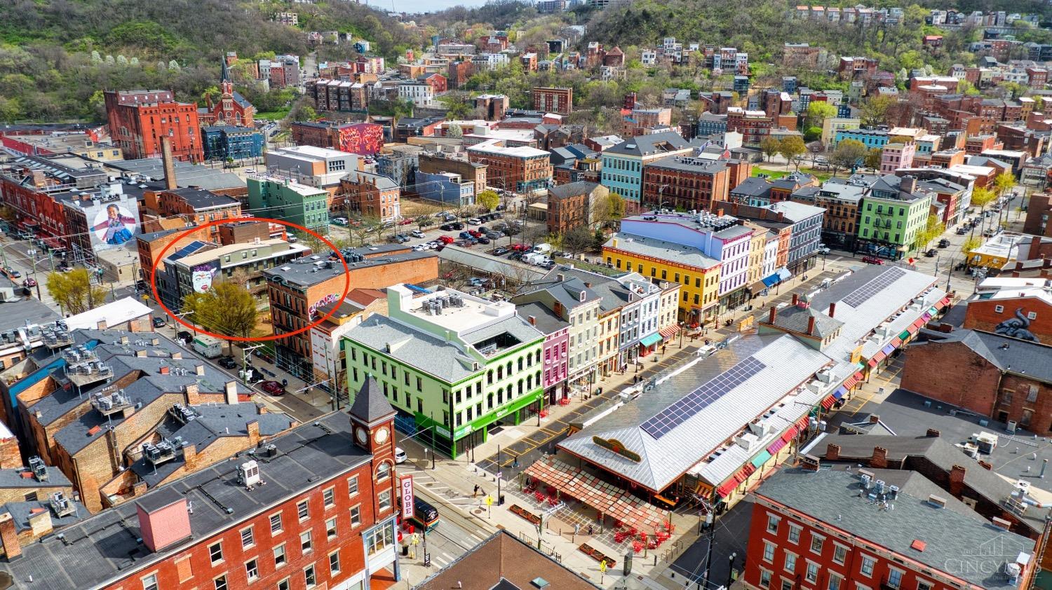 Incredible value + TAX ABATEMENT in vibrant Findlay Market neighborhood! Spacious top floor, two level condo with modern finishes, 2-story ceilings, and expansive covered deck! This is the epitome of convenience being just steps from Findlay Market, hip restaurants, trendy shops, and the street car. Grab some groceries and enjoy cooking in your European style kitchen with quartz counters, stainless appliances, and huge island with counter bar OR grill and dine al fresco on your private covered deck! Relax in your open and airy Living Room with recessed ceiling and loads of natural light. Both levels offer bedrooms with stunning baths offering floating vanities and zero entry showers. Striking hardwood floors throughout! All appliances stay, including washer + dryer. Easy parking in newer Findlay Garage just a block away! TAX ABATEMENT THROUGH 2032! This is THE ONE!