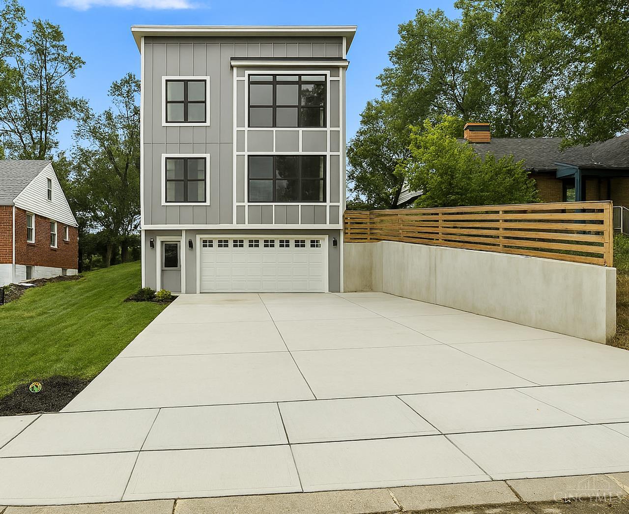 Motivated Sellers! Nearly new home with open-concept layout, high ceilings, and oversized windows with abundant natural light. Kitchen features walk-in pantry and flows into living room and dining areas. Upstairs, the primary suite includes en suite bath and walk-in closet. Lower level offers flexible space with attached bath, perfect for office or gym. Enjoy a large garage, private backyard with deck and patio, and quiet street steps from Pleasant Ridge shops and dining. Built less than 2 years ago, energy-efficient with tax abatement through 2034. Sellers relocating, great opportunity! Agent related to seller.