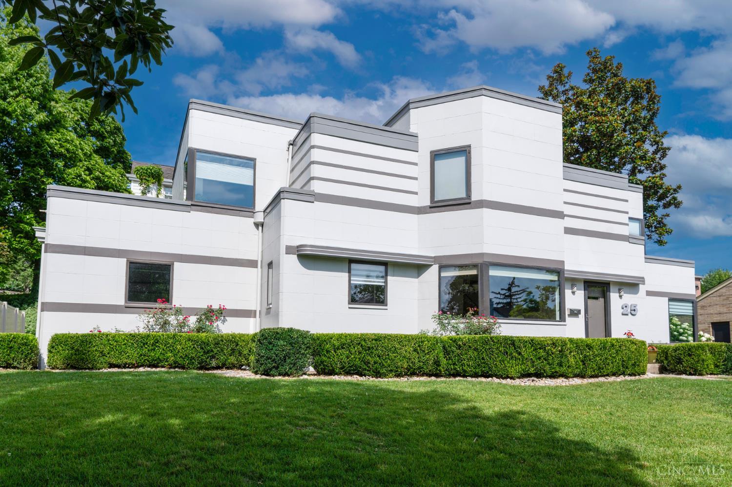 Exceptional Art Deco gem located steps from Ault Park, & once featured in the movie, Milk Money''. This beautifully unique 4-bedroom, 3.5 bath home blends timeless architectural character w modern updates. Gorgeous Tigerwood floors throughout, generous sun-filled rooms. Gourmet kitchen w granite counters, rich wood cabinetry, stainless appliances & wine cooler. Walkout to spacious deck, perfect for outdoor entertaining. Upstairs, find 3 large bedrooms, 2 full baths, & 2 private balconies.  Finished LL with additional bedroom, full bath, & versatile living space, perfect for guests or home office. Attached 2-car garage.