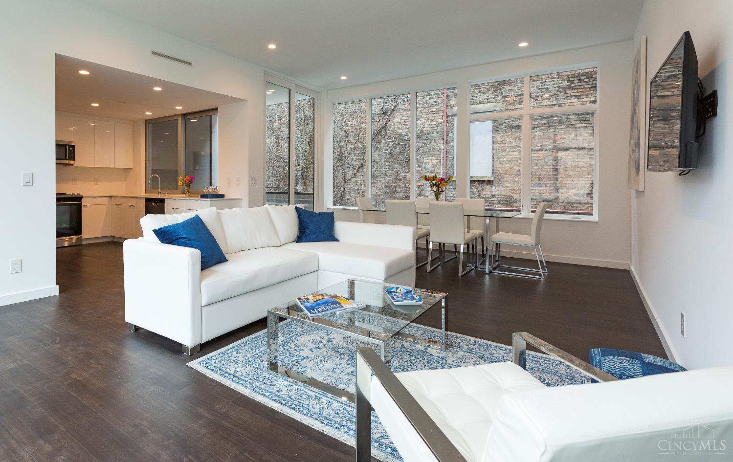 Amazing OTR location for this intimate 3 unit building. Turnkey/move-in ready  available furnished or unfurnished for immediate move-in or as rental investment property (with rental history available). Open, light-filled 1600+ sq ft (as measured by architect) urban retreat located in award-winning building. On the streetcar line, just a block from Washington Park and moments to restaurants, entertainment, cultural venues, shopping, and Findlay Market. Private entry, 10' ceilings, deck, two primary suites each with luxury bath with double vanities, abundant storage space. Sought after, private one-car garage. LEED Gold and AIA award-winning 3-unit building. Tax abated through 2032.