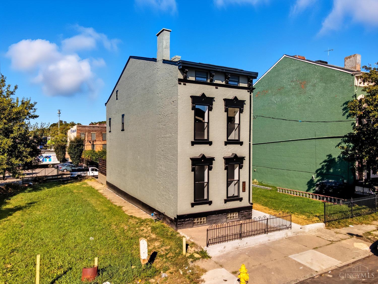 Step into a piece of Cincinnati history on one of the city's most iconic streets, Dayton Street, known as Millionaire's Row. This fully remodeled historic residence seamlessly blends 19th-century architecture with modern finishes for a one-of-a-kind living experience.    Behind the stately brick home, you'll find soaring ceilings, restored millwork, and large sun-filled custom wood windows that showcase the craftsmanship of a bygone era. The home has been meticulously reimagined from top to bottom, featuring a brand-new kitchen with premium cabinetry and quartz countertops with beautiful marble backsplash. The 3 and a half bathrooms evoke a spa-like feel with designer tile, custom vanities, and high-end fixtures throughout.    Every surface  from the hardwood floors to the new mechanicals  reflects thoughtful attention to detail. The result is a perfect marriage of historic character and contemporary comfort.    Tax abatement has been applied for!