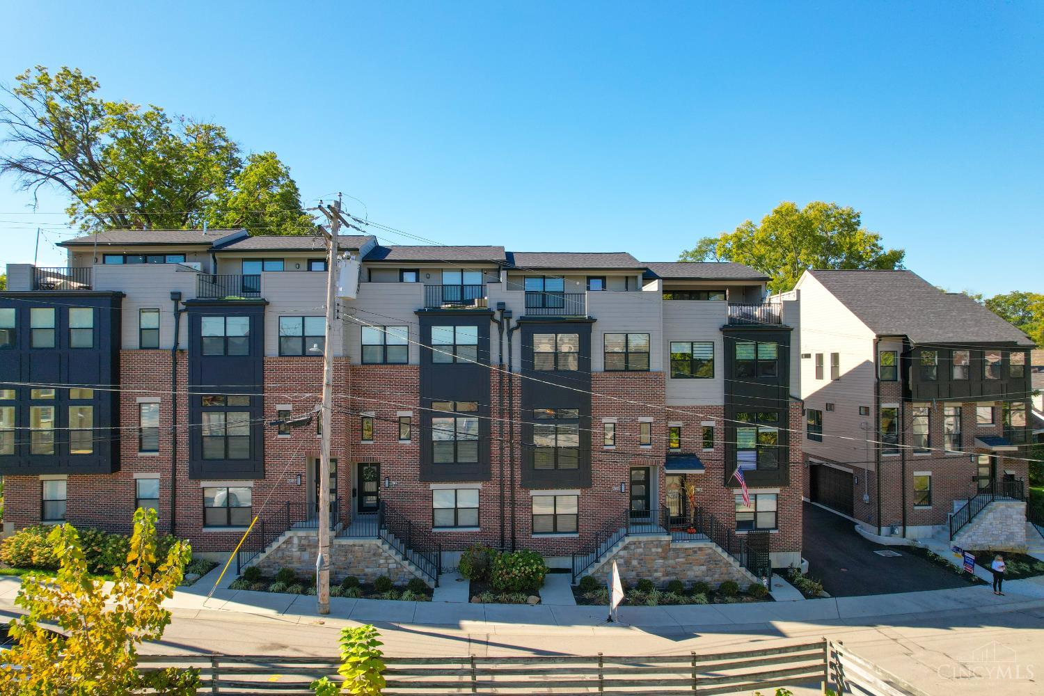Experience upscale city living in this stunning high-end condo just 1 block from Oakley Square. Leed Gold tax abatement through 2036. The versatile lower level features half bath, an egress window-perfect for home office, gym or guest room. The main living area boasts an open floor plan, 9-foot ceilings, luxury vinyl flooring & cordless white blinds throughout, creating a bright, contemporary space for entertaining. Kitchen features SS appliances with gas stove, white cabinets with undercounter lighting & island. Owner's suite offers large walk-in closet, ceiling fan & adjoining bathroom with double closets & laundry room with a utility sink for added convenience. Enjoy your private rooftop deck, overlooking Oakley Square, perfect for morning coffee or evening stargazing. Also, 2 car attached garage completes this rare find.