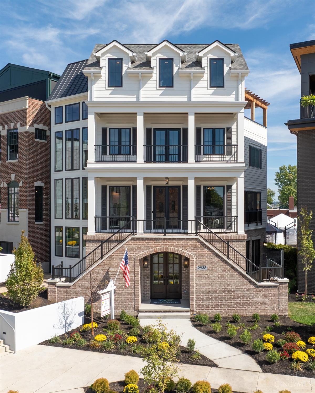 WP Land Company's Homearama 2025 showcase home in Foundry Park at Three Oaks. With over 4,400 sq ft across four levels, this custom residence is built to impress. The southern colonial-inspired exterior delivers standout curb appeal with a grand brick staircase and stunning floor-to-ceiling windows. The first floor features a full wellness suite with gym, sauna, and ice bath, while the fourth floor is an entertainer's dream complete with a game room, full bath, bar, and access to both covered and open rooftop decks. Each level is accessible by a private elevator. The chef's kitchen includes a Wolf 48 range, 60 fridge, and a wine/bar area. Three spacious bedrooms, 4.5 baths, and premium finishes throughout complete this one-of-a-kind home designed as a LEED Gold Tax Abatement property.