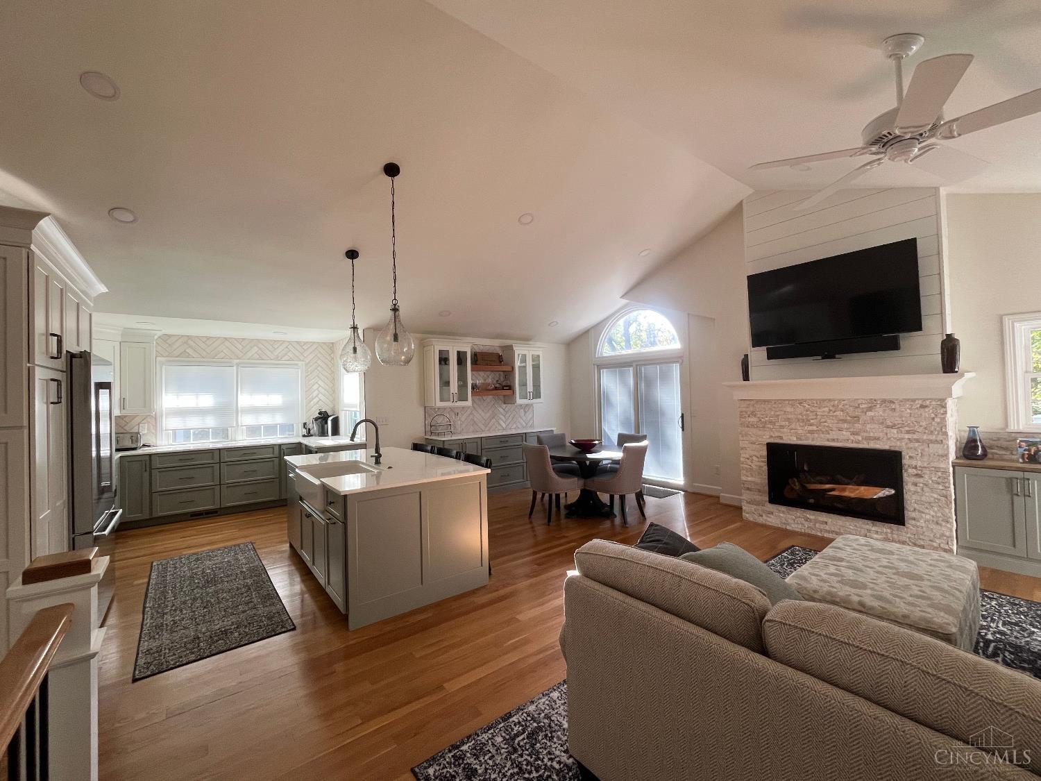 Agent is owner.   Welcome to 19 Greenhouse Lane a light-filled home combining modern comfort with peaceful green space views. The open-concept main level features a designer kitchen with ample cabinets, quartz countertops, & an island that flows into the dining room & the great room with fireplace. Hardwood floors run throughout, with tile in baths and mudroom. Step onto the upper deck to enjoy serene wooded views. The vaulted primary suite has a walk-in closet and en suite bath; a 2nd bedroom also includes an attached bath. The walkout lower level is ideal for entertaining with a wet bar, wine fridge, ice maker, fireplace, and access to a shaded patio. A 3rd bedroom, bath, workout room, storage, & laundry complete the space. Enjoy efficiency with a gas tankless WH and high-e furnace. Beautifully landscaped common grounds and a friendly, private neighborhood with gated access to Wasson Way make this home a true retreat in the heart of Cincinnati. Most furniture included. More pics soon