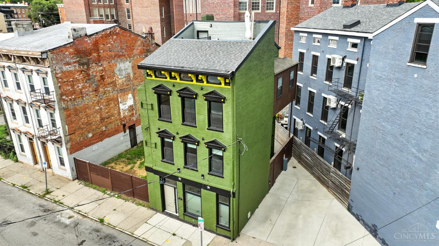 Historic Elegance Meets Modern Luxury in the Heart of Over-the-Rhine!     This 3-bedroom, 2.5-bath fully-renovated & tax abated residence (through 2028),  masterfully blends timeless architecture with sophisticated living. Don't miss the thoughtful attention to detail, the seamless open layout, beautifully crafted kitchen & baths, rich hardwood floors and exposed brick & beams. Neutral palette, fresh & bright paint and newer windows flood the space with light!  Ascend to your private rooftop deck, a true urban retreat offering panoramic city views, ideal for elegant entertaining or serene evenings under the stars. A major additional property highlight includes: an expansive lot that provides opportunity to add on, build a garage with studio and more--the possibilities are endless! Positioned just steps from acclaimed restaurants, historic Music Hall & the vibrant energy of TQL Stadium, this residence delivers an unmatched OTR lifestyle.