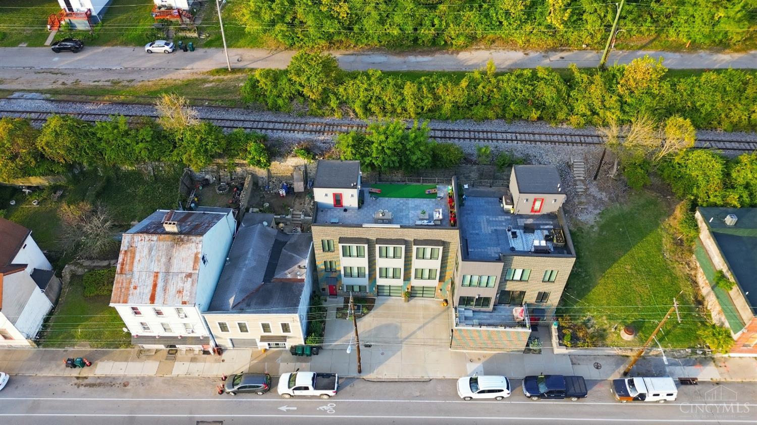 Luxury riverfront living awaits in this stunning 3-bedroom, 2.5-bath home offering 2,933 sq. ft. of sophisticated design and breathtaking Ohio River views. The open-concept layout showcases floor-to-ceiling windows, high-end finishes, and seamless flow throughout. The gourmet kitchen features high-end appliances, quartz countertops, and custom cabinetry, ideal for both daily living and entertaining. A private elevator provides convenient access to each level, including the rooftop deck with sweeping skyline and river vistas. The spa-like primary bath, spacious walk-in closet, and oversized two-car garage elevate comfort and convenience. Perfectly located near downtown Cincinnati, Mt. Adams, and the city's scenic riverfront parks, this residence blends modern luxury with unmatched location.