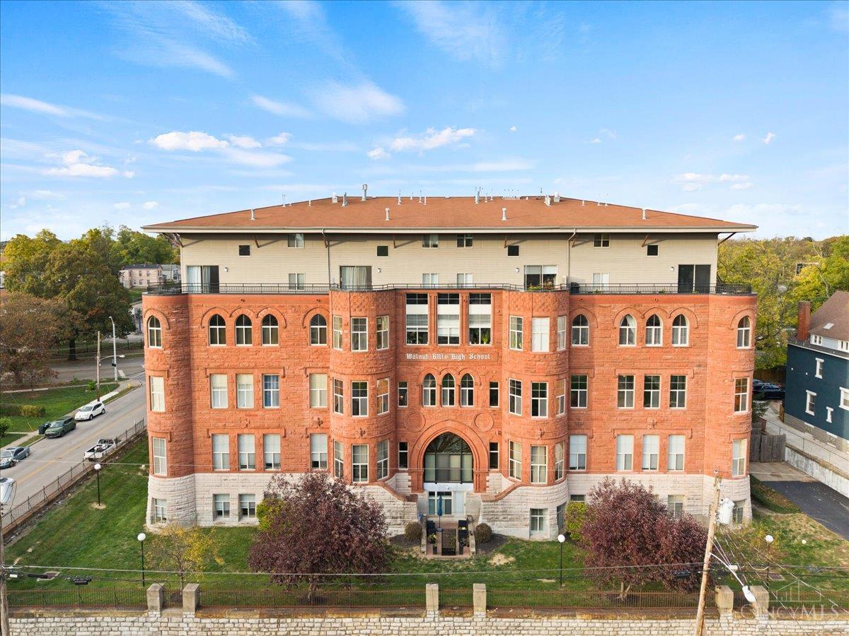 Spacious and modern, two units combined into one stunning condo in the historic Schoolhouse Lofts, located in East Walnut Hillsjust a block from Woodburn Ave and a short walk to Eden Park. This 3-bed, 2.5-bath residence offers over 2,600 sq ft with soaring 14-ft ceilings, hardwood floors, arched windows, and elegant built-in wood cabinetry. The open gourmet kitchen features granite countertops and high-end appliances. Additional highlights include dual HVAC, two water heaters, in-unit laundry, elevator access, a two-car garage plus two parking spaces, storage unit, and a fenced yard perfect for pets. A rare opportunity to own a beautifully reimagined piece of Cincinnati history blending classic charm with modern luxury.
