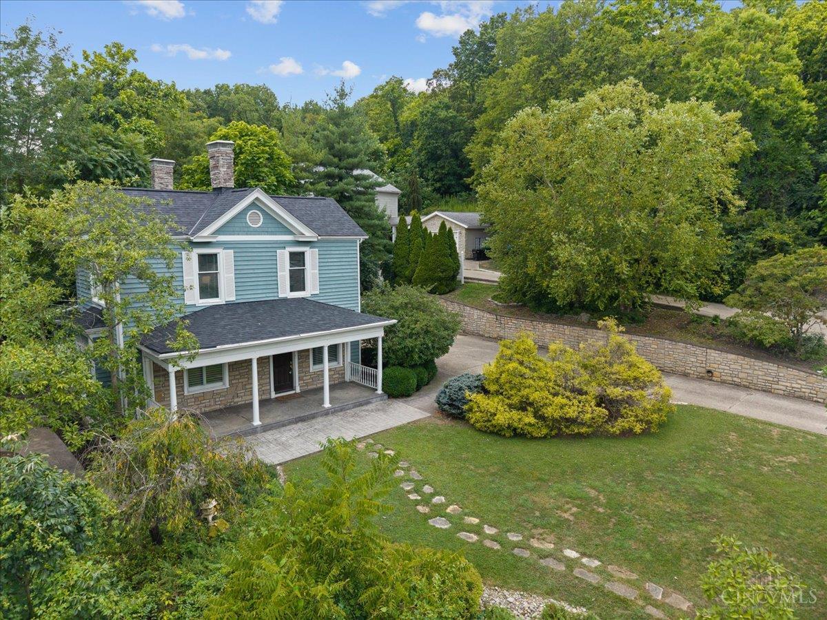 Tucked away on a private hillside street in historic Columbia-Tusculum, this beautifully remodeled 1885 home blends timeless charm with modern comfort. Featuring 10-foot ceilings, rich hardwood floors, and stunning leaded-glass windows, the 3-bedroom, 2-bath layout includes a formal dining room, a flexible study or playroom, and spacious living areas ideal for everyday living and entertaining. The chef's kitchen impresses with granite countertops, a Sub-Zero refrigerator, double oven, a gas range, ample cabinetry, a new faucet, and a convenient walk-out. Additional highlights include crown molding, generous room sizes and closet space, and a new rubber roof with box gutters over the kitchen (2025). Set on a landscaped half-acre lot off a quiet private street with only two other homes, and featuring recent exterior updates plus a 2-car garage, this property offers a rare blend of privacy, space, and historic character in one of Cincinnati's most iconic neighborhoods.