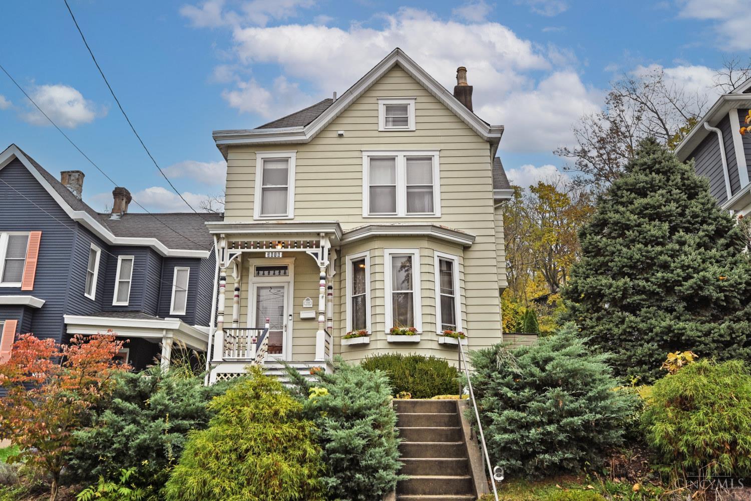 This delightful Victorian is perched above it all on a quiet side street just up the hill from Columbia Tusculum's charming business district.  Move right in & enjoy the many historical details that remain alongside every modern convenience added. An intricately carved front porch greets your guests, while the entry reveals beautiful hardwood floors & millwork, with restored transom & bay windows, filling the home with natural light.  The living room beckons with an original marble fireplace & formal dining beyond walks out onto a wrap-around paver patio with lovely backyard, also accessible from the eat-in gourmet kitchen.  Pantry, coffee bar, full bath & laundry room are also tucked away on the 1st floor. Upstairs you'll find 3 comfortable bedrooms, one with a decorative fireplace, all served by an updated hall bath with designer finishes. The 3rd bedroom offers access to a semi-finished attic that could easily be upgraded to additional living space if desired. AC recently replaced.