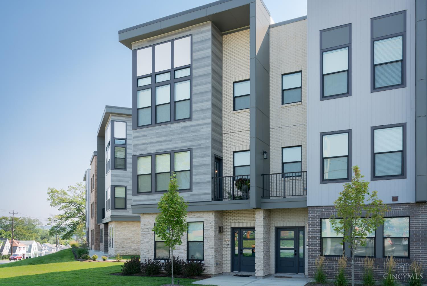 Modern 2022 built three story 3 bedroom townhome, just steps from Oakley Station, Madtree and Oakley Square. Featuring 9 ft ceilings, wood style floors, large windows, and a stylish kitchen with quartz countertops, and soft close wood cabinetry. Dual balconies for seamless indoor-outdoor living. The upper level offers a primary suite with a large walk-in closet, luxury bath, plus an additional bedroom, full bath, and convenient laundry. The lower level includes a guest suite or office with a full bath. Enjoy low-maintenance living with a 2-car EV ready garage-tax abated through 2032.
