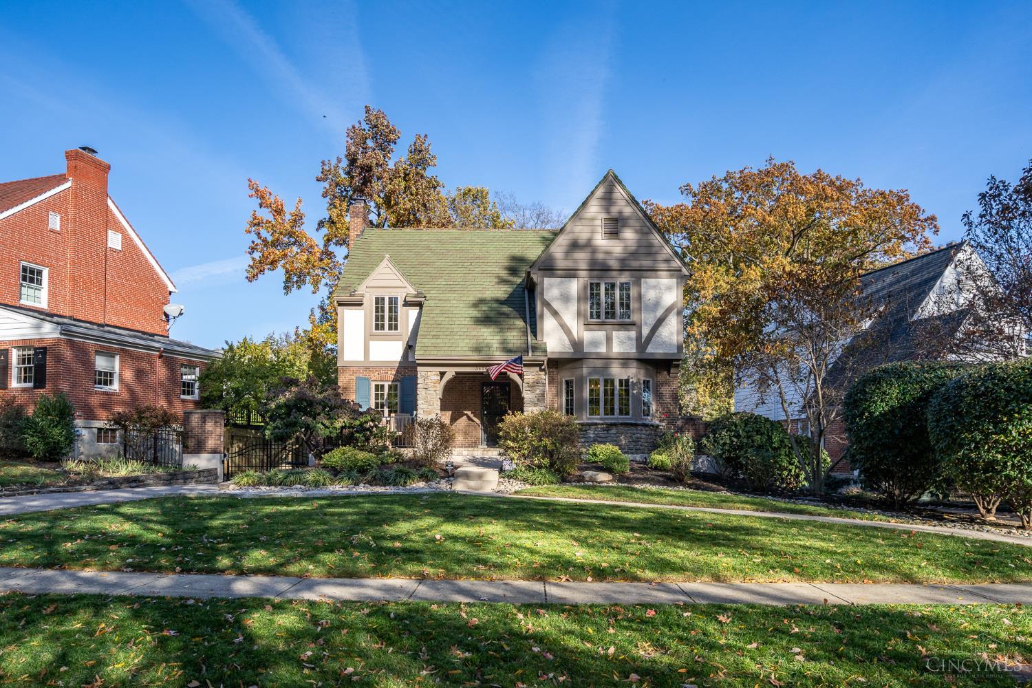 Immaculate, light filled Tudor on one of Oakleys premier treelined streets - 3 bedroom / 3 bath home with 2,150 SF, full of historic charm  & modern updates - beautiful hardwood floors throughout - generous room sizes - Large eat-in kitchen - Lutron lighting & blinds system -  finished lower level rec room with attached bar - private, fenced backyard with large deck & stone patio - Attached, heated 2 car garage -  landscape lighting & irrigation systems - remote operated driveway gate - walkable to shopping, dining, & nightlife, with quick access to  the interstate for an easy commute - Coming soon with Showings starting 11/15/2025.