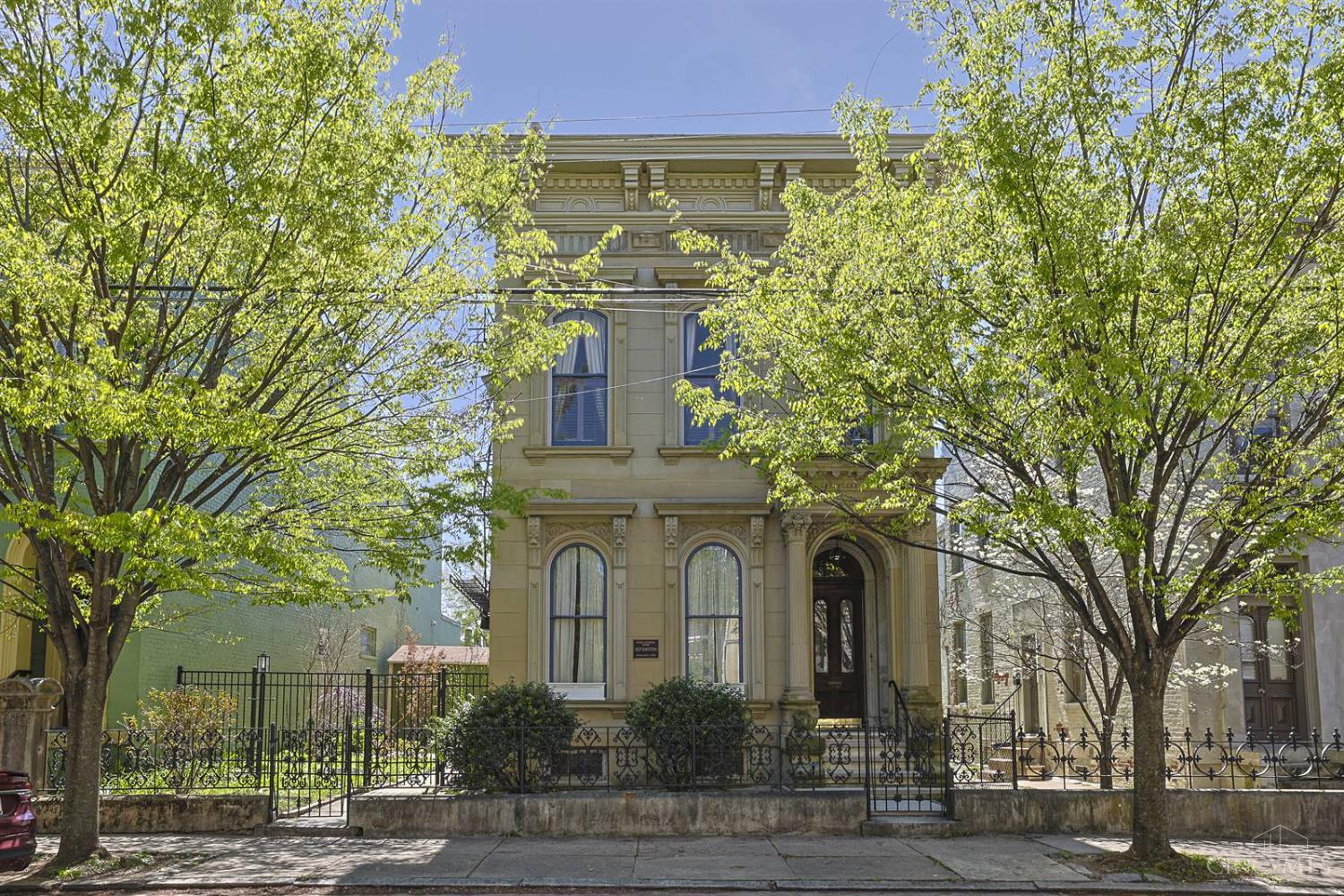 One of Cincinnati's most distinguished addresses - 837 Dayton St sits on historic Millionaire's Row in the National Register's Dayton Street Historic District. This 1880 Italianate masterpiece offers 4 beds, 4.5 baths, and 4,070sqft across three levels of original grandeur: five operable fireplaces with marble mantels, soaring ceilings, and rich period woodwork. Fully renovated kitchen (2025). Primary suite with jacuzzi tub, walk-in closet & sitting room. Third-floor guest suite with sweeping city views and a walkout. Pool relined (2025). 2 new ENERGY STAR furnaces (2022 & 2024), A/C, roof (2023), & water heater (2020). 3-car garage. EV charging. Lower level with a sitting area, direct access to yard & pool, and full bath. Income-producing carriage house (2024) with 2BR/2BA. Positioned in Cincinnati's surging West End - minutes from TQL Stadium and a $332M mixed use entertainment district breaking ground Spring 2026. A rare private estate with historic pedigree and income potential.