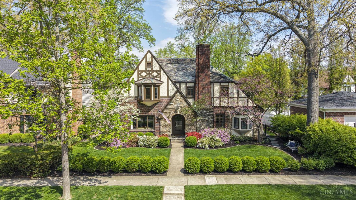 Stunning Tudor home in the heart of Mariemont, where classic architecture meets sophisticated modern living. Rich in character this home showcases original woodwork, archways & more thoughtfully preserved & beautifully complemented by high-end updates thru-out. Designed for both everyday living & entertaining, the main level features 2 private studies, multiple gathering spaces & a seamless layout centered around a gourmet kitchen w custom cherry cabinetry, island seating, & coffee bar, opening to a warm hearth rm & additional dining area. The newly added primary suite is a luxurious retreat, complete w/a walk-in closet, dressing area & an elegant bath. The expansive LL offers over 1,400 SF of addl living space, including a media rm with 9 ft ceilings, wet bar, fitness rm, sauna, spa bath & 2 flexible bonus rms w/endless possibilities.  Step outside to a covered patio & outdoor kit ideal for hosting or relaxing. This exceptional home offers space, character & modern living!