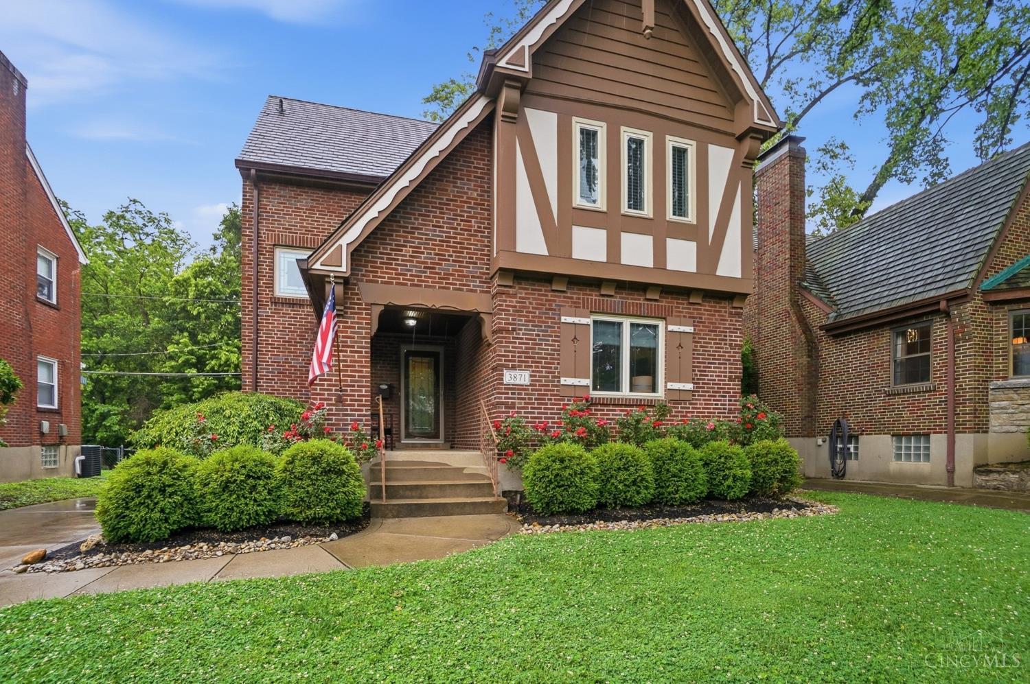 This home has it all! Storybook Tudor filled with timeless appeal and all the updates. Hardwood floors throughout and an updated kitchen opening to the spacious dining room create the perfect flow for everyday living and entertaining. Features include custom wood cabinetry, granite counters, stainless appliances including Bosch dishwasher, refrigerator and a beverage fridge, plus an adjacent mudroom with a full bathroom for added convenience. Traditional living room centered around a gas fireplace. Enjoy outdoor living on the covered front porch or rear deck overlooking the fully fenced backyard perfect for pets and play. Upstairs offers 3 spacious bedrooms and a beautifully updated full bath including a walk-in shower with built-in seat. Finished lower level provides flexible bonus living space ideal for family room, home office or playroom, along with a large laundry/utility room, half bath and direct garage access. Showings start 5/28.