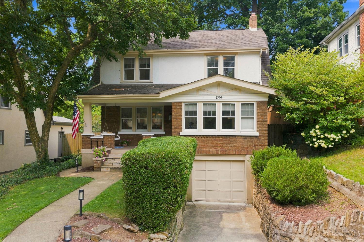 Set on a quiet, tree-lined street in the heart of Hyde Park, this 1923 two-story carries the character of its era while living easily for today. You feel it in the sunlit wood floors that run across the main level and a dining room made for gathering. The kitchen has been tastefully modernized, with quartz counters, stainless appliances, a center island, a built-in work station, and crown-topped cabinetry over a tiled backsplash. Downstairs, a finished lower level with a full bath flexes from guest quarters to home office. Out back, a raised deck overlooks a privately fenced yard framed by mature trees. A rare blend of period charm and thoughtful updates in one of Cincinnati's classic neighborhoods.