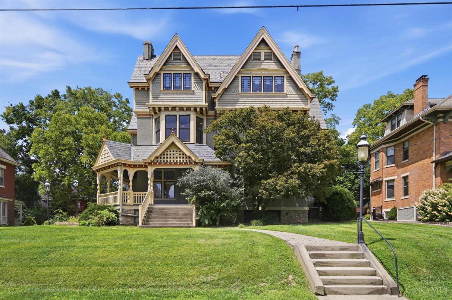 Step into Cincinnati history in Historic East Walnut Hills with this stunning Queen Anne Victorian, built in 1880 and thoughtfully updated for modern living. Boasting over 5,700 sq ft across three stories, this remarkable home features 7 bedrooms, 6 full baths, and 3 half baths. Beautiful original woodwork, wood floors, stained glass, and other architectural details blend seamlessly with modernized features throughout. The spacious kitchen offers a 6-burner gas range and double refrigerator/freezer. Enjoy the gorgeous covered front porch, paved patio, rear shed, and fire escape. Located in rapidly revitalizing Walnut Hills, just minutes from Downtown, Eden Park, Mt. Adams, Xavier University, and the University of Cincinnati. A rare opportunity to own a piece of Cincinnati history with exceptional space, character, and convenience!