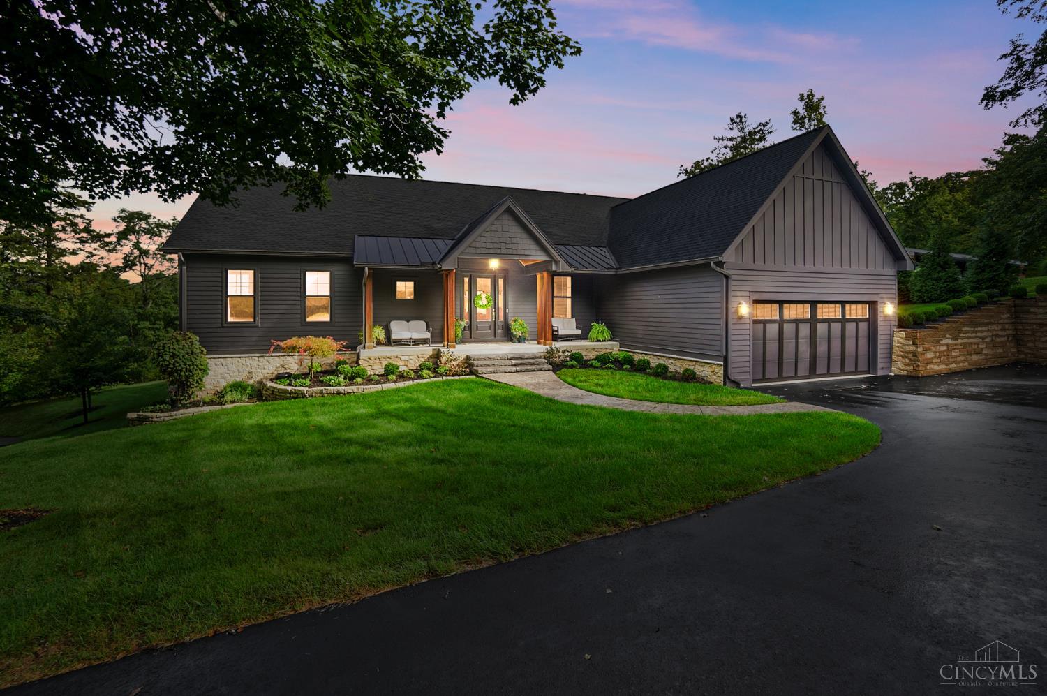 This exceptional custom home sits in a private wooded community spanning 200+ acres, overlooking a beautiful lake with professional landscaping and private trails. Conveniently located minutes from I-275, downtown, the airport, schools, parks, & amenities. Designed for effortless first-floor living, the open floor plan features 10-foot ceilings, designer finishes, a private office, & seamless indoor-outdoor living. The chef's kitchen boasts custom Amish cabinetry, Viola marble, a La Cornue double-oven range, & walk-in pantry. The luxurious primary suite offers a spa-inspired bath with steam shower, chromotherapy lighting, & Toto integrated toilet/bidet. A second ensuite bedroom completes the main level. The finished LL includes a rec room, gym, guest suite, bar, & Trackman golf simulator. Enjoy a screened porch, oversized patio, fire pit, & serene lake views, plus a Generac generator, Sonos sound system, & custom built-ins. This one-of-a-kind property feels like a year-round retreat.