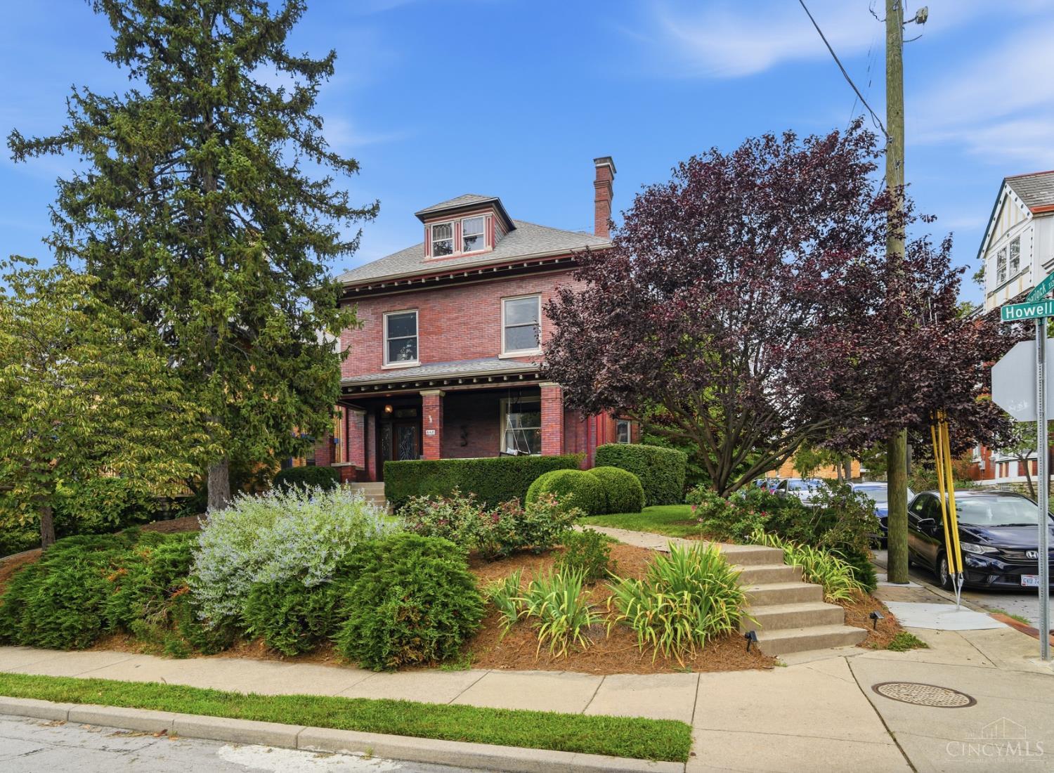 Come home to this stately Gaslight Clifton home, proudly perched on a corner lot with an oversized 2 car garage on the side street.  Enjoy greeting your guests on a covered front porch before welcoming them into a lofty open foyer. A beautiful staircase lands where bench seating & leaded transoms accent an original front door. The formal dining beyond is filled with natural light & features a handsome hearth with double pocket doors separating it from the foyer & living room. Also on this floor are a powder room, back stairwell & gourmet kitchen which, like the living room, opens onto the shaded backyard. Upstairs 2 comfortable bedrooms & a study are served by a charming hall bath & large laundry room with custom cabinetry, while on the 3rd floor you'll find 2 more bedrooms, a 2nd full bath & a lovely bonus room in between. On the LL lies a family room retreat with 3rd full bath nearby as well as multiple utility rooms - ready to appoint as you see fit for hobbies & storage.