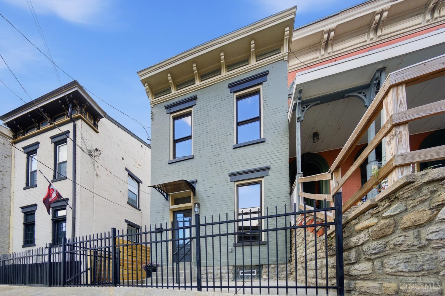 Historic charm meets modern updates in this beautifully renovated 1890 Italianate with a 10-year tax abatement! Soaring ceilings, abundant natural light, and classic character blend seamlessly with today's modern conveniences. The NEW open-concept cook's kitchen is perfect for everyday living and entertaining. The spacious primary suite features a walk-in closet and luxury bath, while the first floor bedroom with outside entrance can flex for guests, adult children or as a super home office. 2nd floor laundry, NEW zoned high-efficiency HVAC, NEW electrical, plumbing, windows, doors, roof, and flooring make living here almost worry free! The large attached rear-entry garage featuring an oversized insulated door is an especially hard-to-find urban living amenity. Ideally located just steps from OTR and Downtown, and minutes from Walnut Hills and Clifton. It's ALL done...just move in and enjoy!