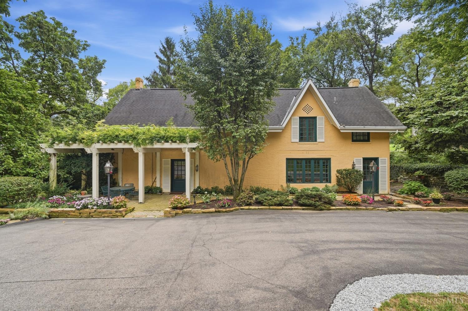 Set far back from Lafayette Avenue at the end of a long, tree canopied drive, this carriage house occupies nearly an acre of terraced gardens and mature grounds, offering a rare sense of privacy in the heart of Clifton. The property carries real history: it once served the storied Neave/Sabin estate, home to Dr. Albert Sabin during the years he developed the oral polio vaccine just steps away. Today the carriage house stands on its own as a four bedroom, two full bath home that is completely move-in ready, with updated mechanicals, custom cabinetry, French doors, and a walkout lower level. For a buyer with vision, real opportunity remains to expand or reimagine the space further. Beautiful grounds, deep privacy, and a piece of Cincinnati history make this an ideal canvas to create your perfect home.