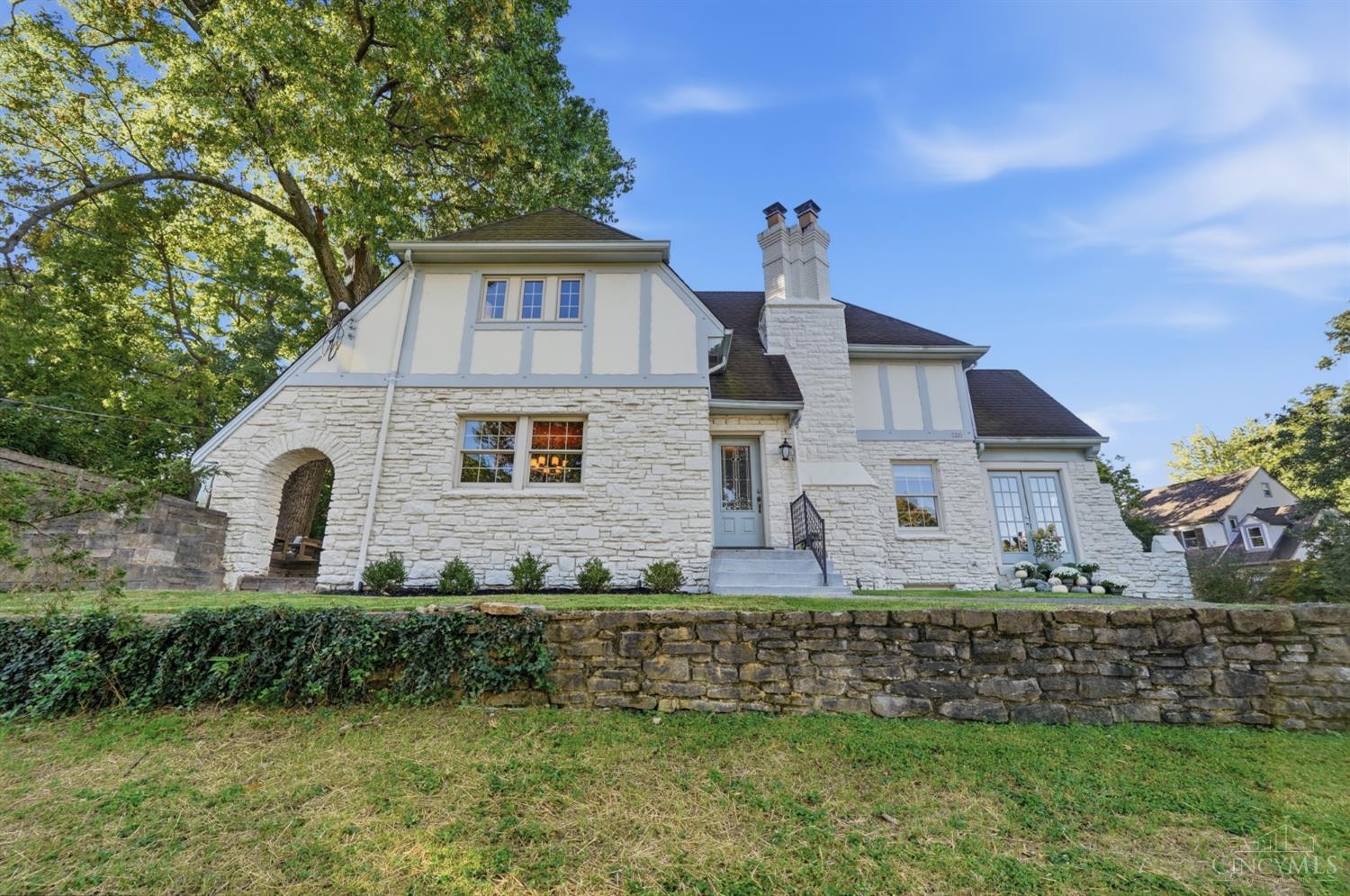 In the heart of Mt. Lookout, a block from the Square & favorites including Delwood, Zip's, VV Italian and Mt. Lookout Joe's, this charming Tudor blends timeless character with everyday convenience. Offering 4 bedrooms & 3 full baths, the home welcomes you with abundant natural light, beautiful hardwood floors & architectural details throughout. The updated kitchen pairs style & function, while generously sized bedrooms & an updated second-floor bath provide comfortable living. A solarium offers endless possibilities as a home office, playroom or yoga retreat. The walkout finished lower level adds valuable living space & a full bath. Outdoors, enjoy a beautiful side patio, perfect for relaxing or entertaining. An attached garage & two driveways provide exceptional off-street parking. Situated on the corner of Linwood & Rennel, a private cul-de-sac street, this special home offers charm, versatility & an unbeatable location in the Kilgour School district.