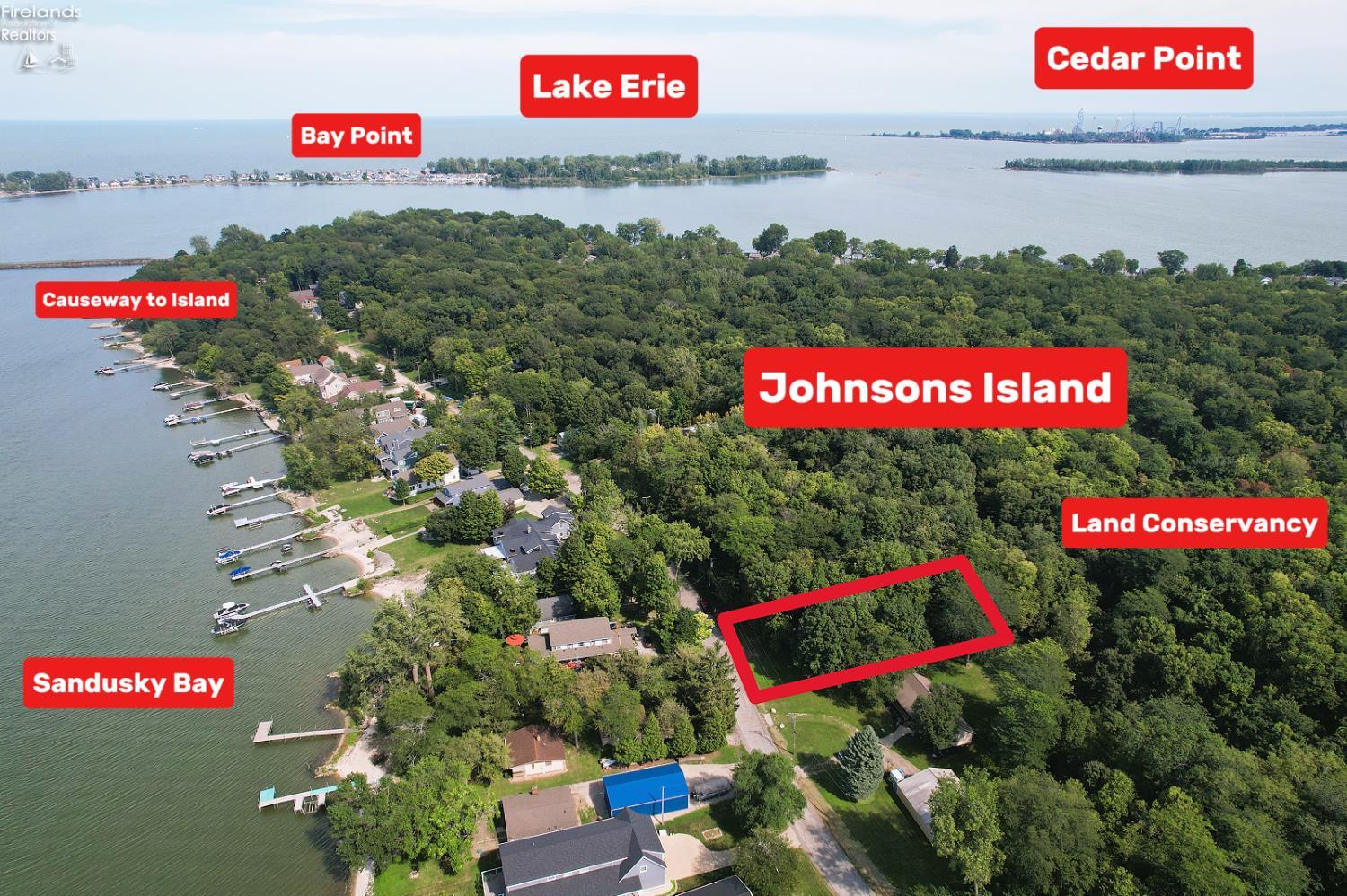 Aerial view of Johnsons Island, with waterfront homes, docks, and labels for Lake Erie and nearby landmarks.