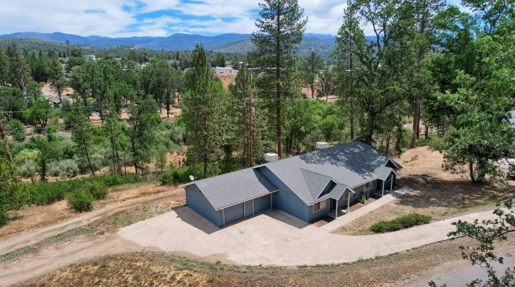48411 Black Oak River Road Oakhurst, California Great duplex is now available! Excellent location close to Oakhurst, Bass Lake and Yosemite National Park! Ideal to live in one home and rent the other or to use for a 2 family set up or an Air BnB! Each unit is 1112+/- sq. ft. with 2 bedrooms, 2 bathrooms, living area and kitchen with breakfast bar, walk-in pantry, dining area, walk-in master closets and a laundry set up in the closet. Each home has laminate flooring and carpet, ceiling fans, tile counters, kitchen appliances including the refrigerators and a nice patio area. Set on .46+/- acre with a creek, there are lovely trees and views! Concrete driveway leads to the attached garage with a storage bay. A wonderful investment opportunity that you won't want to miss!