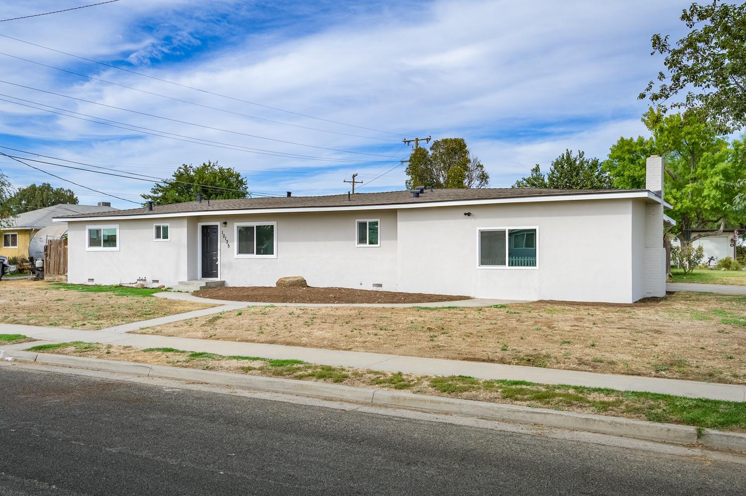 Welcome to 10125 El Toro Way in Hanford, CA! This fully remodeled home features three bedrooms and two bathrooms. The living room has a cozy fireplace. The open kitchen is equipped with modern appliances. Step outside to a spacious backyard, perfect for relaxation and fun. This charming property is move in ready and waiting for you to call it home!