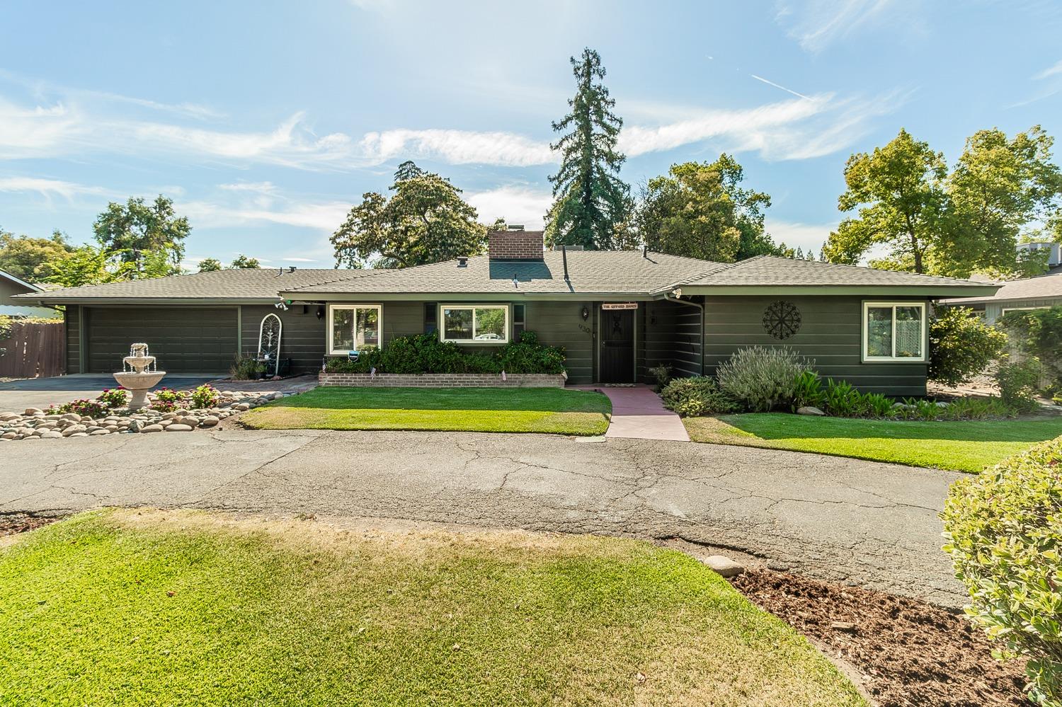930 S Park Circle Drive Fresno, California Welcome Home! At 2,200 sq ft with an expansive .61 acre lot, this home is a rare find inside city limits. In addition to the three bedrooms, there is a bonus flex space that can be used as an office, bedroom or utility room. Updated kitchen features quartz countertops and newer appliances. Additional features include newer composition roofing, bonus storage behind the garage, a cute greenhouse and a she shed currently used as another guest room. Enjoy cool evenings around the firepit amongst a variety of fruit trees and surrounded by privacy fencing. Out front you'll find plenty of parking space with a circular driveway, street parking, a 2-car garage and additional land to place your RV, boat or any other toys you may have. This property also offers a road parallel to the canal with two gates leading into the HUGE backyard. So Many Options!Appreciate the low bills with 34 solar panels by Sunrun (PPA).