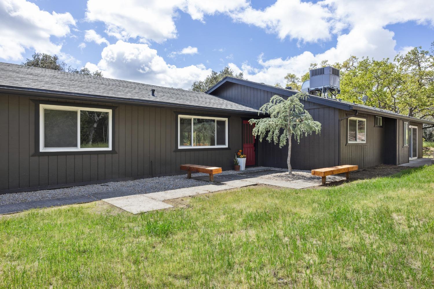 Take a step into your dream home today! With 1,792 sq ft of living space on a massive 31,363 sq ft lot, this residence combines comfort and modern elegance. Tucked off the road front and at the end of a secluded driveway, there is plenty of privacy amongst the retreat-like setting. The brand-new oversized wood deck is perfect for entertaining or relaxing surrounded by the serene landscape and oak trees. Inside you'll find new laminate flooring in the common areas and new carpet in the bedrooms. The home has fresh interior and exterior paint for a crisp clean look and allows for an easy move-in. The kitchen features new stainless-steel appliances, new quartz countertops and freshly painted cabinets. The living room has lots of natural lighting and a cozy fireplace. The primary suite offers direct outdoor access, dual sinks, a skylight, and a fully renovated walk-in shower. One of the additional bedrooms includes access to the deck-ideal for guests or a home office. With a 2-car garage and convenient access to restaurants and easy commute routes, this home checks all the boxes. It would be a great primary home, a vacation home and even an Airbnb. Don't miss your chance-schedule an appointment to tour the home.