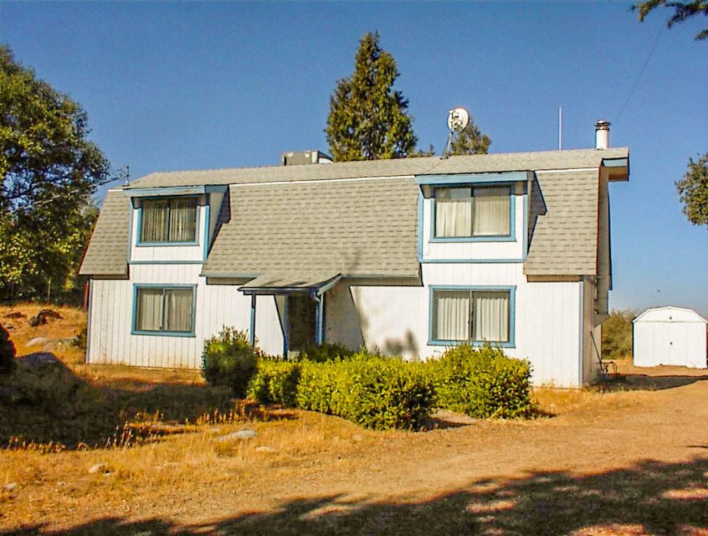 This secluded 4.6 acres on Greenhill is at the 3000' elevation, giving you cooler summer temps and an occasional winter snowfall. It has been improved with a well maintained 3br2ba 2-story barn style residence with 1720sqft. It also has a nice freestanding 2 car garage/shop located behind the home on a separate pad. This is a nice property with over 650 feet of road frontage giving it excellent privacy. The home is sited well off the road on an elevated pad in a setting of redwood, cedar, and pine trees plus a particularly large pepperwood tree. Built in 1983, the home has a large open living area with a cozy free standing woodstove, a light and airy kitchen with 1 bedroom on the ground floor. Heating and cooling provided by a dual pack HVAC system and the well is a very serviceable 10gpm. The entire property is fenced with some cross fencing.