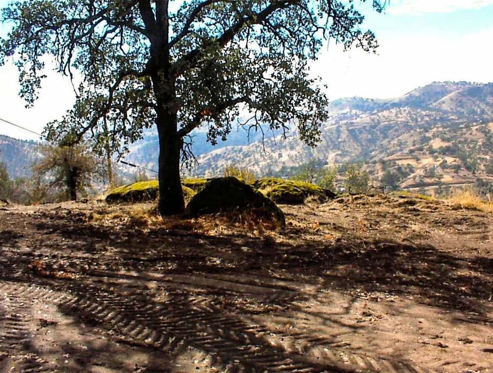 This is the ultimate in private. Located at the end of a very quiet cul-de-sac lane, this outstanding 4.6 acre parcel wraps you in a cloak of seclusion and treats you to panoramic western views of the surrounding valley and mountains beyond. This property truly feels right when you stand on it. This is a triangular property that uses its shape and the surrounding terrain to insure that you will never have a close neighbor. This is 5 acres that feels like 20!All of the hard work has been done. A professionally constructed drive winds down from the cul-de-sac to a broad flat where a large pad area has been roughed in. At one end, you will find a newly drilled well that produces an exceptional 21 GPM, enough water for all of your potential uses. Power is available at the property line. The pad area features a unique combination of mature trees and amazing rock formations that provide you with a dramatic blank canvas to design and build a truly private mountain retreat of serenity and seclusion. Hillside parcels often offer exceptional views, but present development challenges and are limited in usable land. This lot is a rarity. As we said, the hard work has been done. The drive drops you down to a broad bench providing plenty of room to build your dream home and the natural rock benches provide the perfect opportunity for unique landscaped viewing sites of the gorgeous valley view and evening sunsets. You will discover many other spots on this lot to unleash your creative landscaping talents.This isn't the run of the mill property. While, hopefully, my description has whetted your appetite to explore further, there are times that words won't suffice. This is one of those times. This property must be walked. We have a saying here that the mountain calls to you. You will know you are on the right property when it hits you in the pit of your stomach. While you could just drive down to the bench area, my advice is to start at the top and walk the entire way down. Enjoy the views and soak in the natural serenity of this property. Who knows? The mountain may just call to you. Regardless, you won't regret the trip. One final note : This is Squaw Valley, not Yokuts Valley. People up here don't recognize the State of California's attempt to cancel our name or our 150 years of history. Seller has a California Real Estate License.