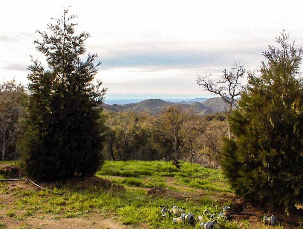 Ultra-secluded 5 acre hillside parcel with excellent valley view. Property is gated and mostly fenced and has been improved with a graveled driveway and huge pad with a western view of the valley. Additional improvements include a new 20gpm well with pump and a water storage tank placed above the pad area for gravity flow. Pump can be operated by generator. Lot has a heavy coverage of live oak screening the pad from view. Fencing provides two areas for maintaining animals. Storage container is not included in sale but may be available for purchase. Seller is willing to consider carrying paper with an acceptable down payment and terms.This is a nice parcel at the 3,100 foot elevation, so it is cooler in the summer with occasional winter snow. A great property for someone looking for a lot of privacy and still wanting to enjoy a mountain view.