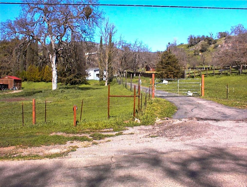 Well maintained 1984 manufactured home on permanent foundation with detached 2 car garage on fully usable 2.31 acre lot. The propety is fully fenced and cross-fenced with a gated and paved driveway plus additional outbuidings and animal pens. Home is nicely landscaped with a fenced yard for pets and children.Home is 3br2b with 1,680sf with vinyl attractive siding and a nice open floorplan with an isolated master. Living room has vaulted ceilings with a functional brick faced fireplace. Nice kitchen with tile counters, breakfast bar, and large dining area. Wood floors throughout and ceiling fans in living room and all bedrooms. Home is in nice condition and shows pride of ownership throughout.This is a very functional property that has been well planned with easy access to all areas. Very nice terrain with a nice mixture of open areas and mature oaks. There is a secondary gate off the road to the front pasture area with a nice outbuilding. Quiet area with easy access back to Highway 180 and only 1/2 mile to the Country Store. This ain't perfect, but it's very nice and offers a lot of living at a great price.