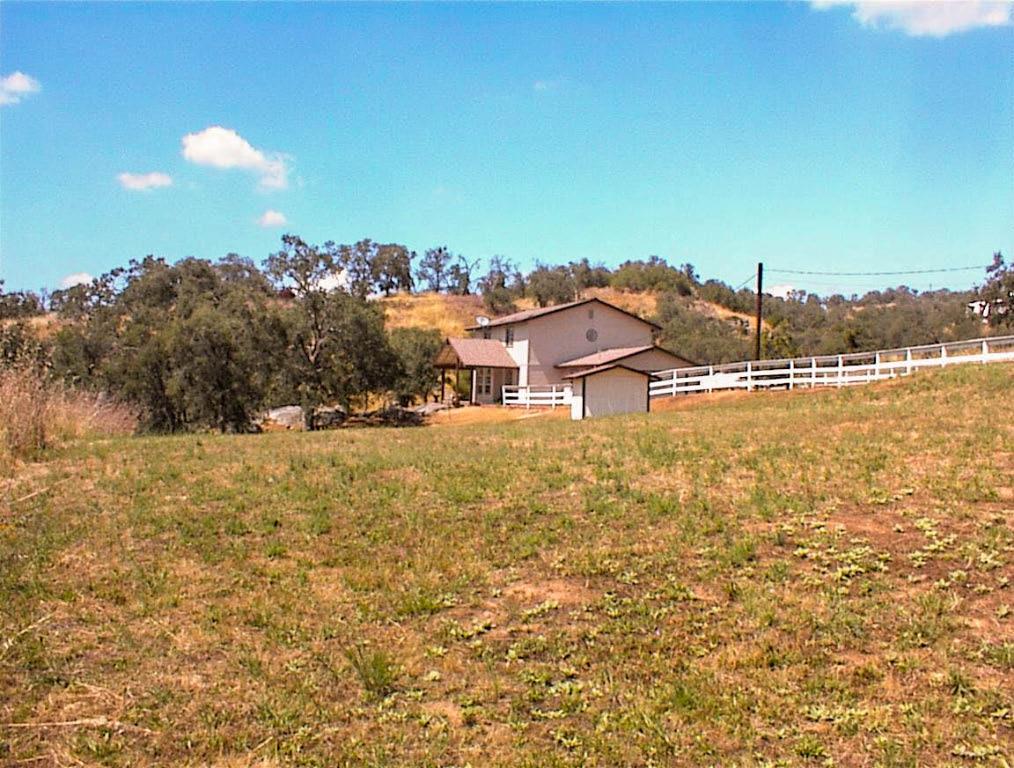 Located just off Highway 180 for an easy commute to the valley, this secluded corner lot is home to a terrific 2 story Bricker custom 3br2.5ba residence. The owners, and original builders, are relocating out of state and are hoping to find a new owner who will love this property as much as they have. And, there are many features worth highlighting.This is a great parcel with frontage on George Smith and Hickory. It slopes lightly up from George Smith and the home is sited at the top of the lot with driveway access from Hickory to a very secluded setting with a western view overlooking the entire property. The lot has a nice coverage of mature oaks and some unique rock features highlighted by a gorgeous natural rock garden at the front of the home. The property is fenced and the AE zoning allows for a variety of farming and animal related uses. This parcel has 2 wells and there is a second septic system for a RV site.The home is a Bricker custom 2 story built in 1993. It offers 1,839 square feet with 3 bedrooms and 2.5 baths and an attached garage. It has a nice open floor plan with a large living room and dining area off of the kitchen. The kitchen features pebble-tech floors and gas appliances with a utility room and half-bath off of the kitchen. The dining area has a slider to the outside and there is a separate exit off of the utility room. A small portion of the garage has been converted into a very cozy office space. The bedrooms are nicely sized. The front of the home has a beautiful covered deck that overlooks the rock garden. It's a great place to relax in the evening and enjoy the sunset. The entire property has been immaculately maintained.The handyman of the family will really enjoy the 24x48 shop that is divided into an open work area, shop or hobby room, and garage area. It has separate electrical service with 220 power. The RV site is adjacent with water, septic, and electricity. The shop area is a great addition that offers some real flexibility for the new owner.This is one of the nicest properties in the area offered by the original owner. It has quick access to the highway for an easy commute to the valley and has been meticulously maintained by the owner. With plenty of usable land, two wells, and a shop, the new owner will find a terrific canvas to create their new rural lifestyle. Showings are by appointment only and the seller is quite firm on their price.