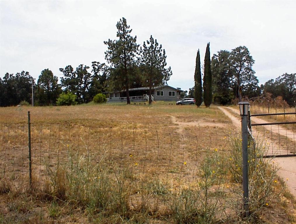 Location - Location - Location !! Here's a new listing on Indian Guide in Squaw Valley. Located just over 1/2 mile from Hwy 180, this 4.63 acre property has plenty to offer. For starters, it has outstanding terrain that lightly slopes up from the road with nearly level ground in back. It backs up to a large ranch property, so no neighbors in back. Indian Guide Road is perhaps the most sought after location in Squaw Valley with easy access to the highway, 1 mile to commercial services, nice views, and no annual road maintenance fees. There is a new home next door and a recent build across the street. It's a nice area.This property has a 1986 manufactured home on permanent foundation set well off of the road near the center of the lot. It has an excellent view of the surrounding valley area. The lot is fully fenced with the home area separately fenced and there is plenty of room for any outbuildings you might want as well as areas for animals or agricultural plantings. The land is zoned AE which allows for a full variety of farming and animal uses as well as home occupation types. The home is 3br2ba with a nice open floor plan and an expanded master bedroom. The kitchen has granite counters and a nice island food prep area plus a large pantry. The living areas and kitchen have newer wood floors with carpeting in the bedrooms. The master bedroom has been expanded to include a sitting room and private deck area. The utility/service room has an exit to the rear deck area and the home has covered front and rear decks plus a large storage building in back. There is also a nice sitting area under a large oak in back.This is a nice property. The home is in good condition, but the exterior needs a little TLC. This would be great for a family farm with plenty of room for a variety of animals, garden areas, and family orchard, as well as room for a shop and barn. It's not often that we can say a property is fully usable, but this one certainly is. Come take a look. Showings are by appointment only.