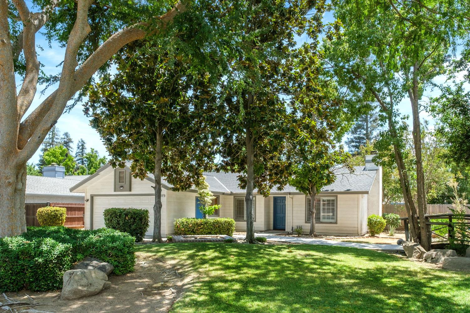 Welcome home to this beautifully updated single-story residence nestled in the desirable Fig Garden Loop neighborhood. This inviting 3-bedroom, 2-bath home offers a bright, open layout enhanced by soaring vaulted ceilings and stylish flooring throughout.The remodeled kitchen is designed to impress, featuring granite countertops, stainless steel appliances, a farmhouse sink, and updated cabinetryperfect for both everyday living and entertaining. The spacious living room centers around a cozy fireplace, creating a warm and welcoming atmosphere.Retreat to the private primary suite with vaulted ceilings, while two additional bedrooms provide flexibility for family, guests, or a home office. Step outside to enjoy the expansive backyard complete with a covered patio, lush lawn, and mature landscaping, offering plenty of room for outdoor gatherings, play, or relaxation.Situated on a generously sized lot, the home also features an extended driveway with ample parking, indoor laundry, central heating and air (AC unit replaced June 2025), and an attached two-car garage. Conveniently located near parks, shopping, dining, and within close proximity to schools, this move-in-ready home combines comfort, style, and an excellent location.Don't miss the opportunity to make this charming Fresno home your own!