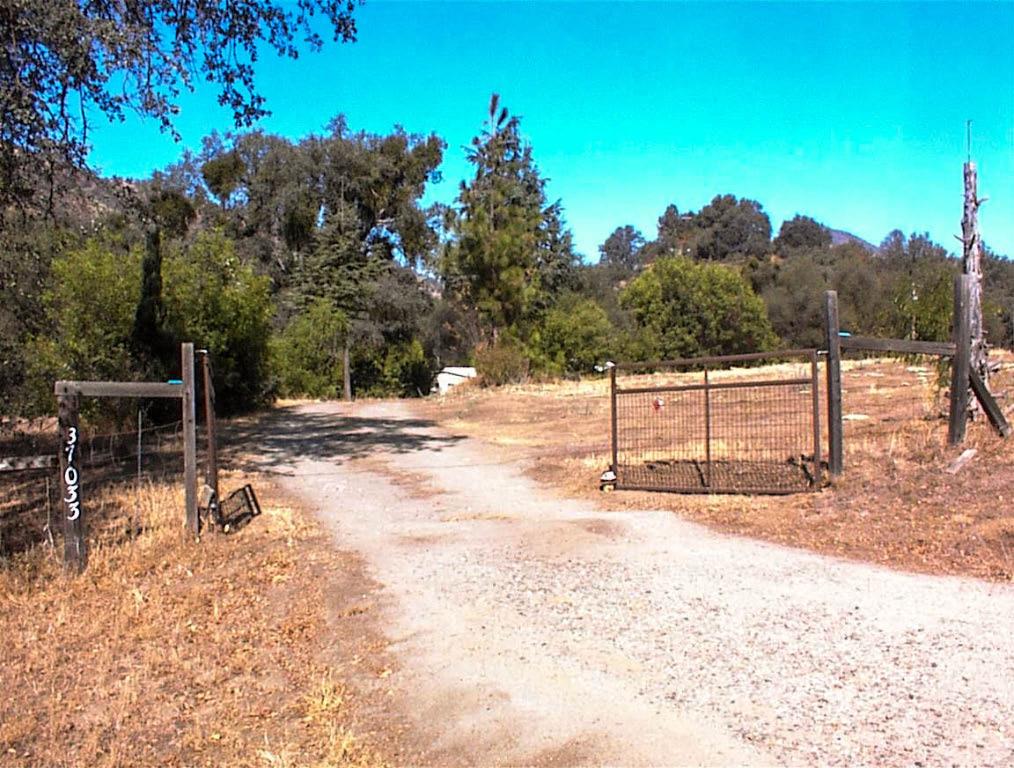 Very nice older manufactured home only 1 mile from Hwy 180. This property has a Dunlap Road address but is on a dirt cul-de-sac known locally as Blue Oak Lane. The home is a 1974 model on permanent foundation and is in good condition with covered front and rear decks. Home is 3br2ba with isolated master. 3rd bedroom currently used as office. Open floorplan with dining off of kitchen and large living room.This is a nice parcel with the home sited well off the road for outstanding privacy. The well is only 100 feet deep and an exceptional 100 GPM. There is also a generator for the very occasional power outage. That's a nice feature when living in the mountains.The property is mostly fenced with some cross fencing. The seller has made mulitple garden areas and planted a multitude of conifers that are now mature plus a nice coverage of mature oaks of multiple varieties. Additional improvements include an above ground pool, parking shade for 2 cars, and a nice patio deck along the seasonal creek. All-in-all, this is a truly serene setting with a very affordable price.This isn't a fancy property, but,over a 40 year period, the owners have made it a very comfortable place to call home. This is a great location only 1.5 miles from the local store, gas station, and coffee shop and only 3 miles to Dunlap School.
