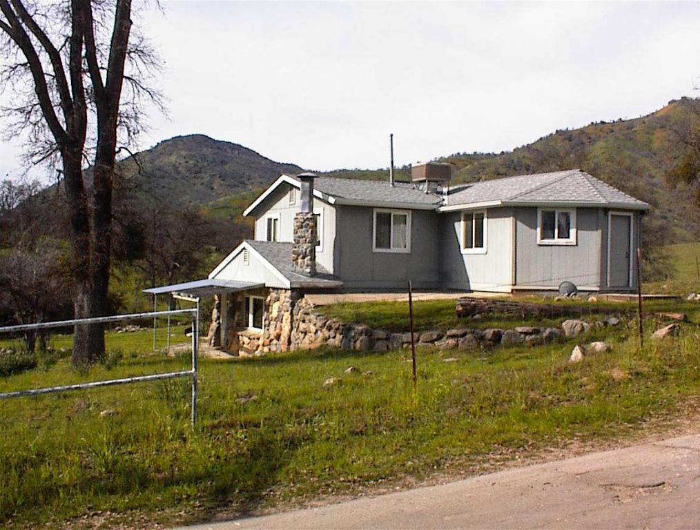The Rock House is on the market. This unique 2 story home is located on Hopewell Road only 1/4 mile from Highway 180 and the commercial services of Clingan's Junction (gas, coffee shop, and market). This unique home is surrounded by large ranch properties and enjoys tremendous views of the surrounding mountains. With its easy access to the highway, this property is ideally situated for use as an Air B&B or VRBO short term rental.The entrance to Kings Canyon & Sequoia Natonal Parks is only 16 miles east of the property.The home is 3 bedroom 1.5 bath with 1,300 square feet and an isolated master bedroom with separate exit to the outside. The living area is modest in size combining living room, kitchen, and dining areas. The living room has a beautiful rock fireplace. The exterior of the home is a combination of native rock walls and wood with rock retaining walls. The home is in generally good condititon with new carpeting upstairs, granite counter in the bathroom, and new dual pane windows. The flooring in the living area is finished concrete. This is truly a unique offering. The home has a very rustic and natural beauty and the setting is ideal. Showing is by appointment only and the seller is looking for cash or a conventional buyer. Seller is looking to sell home in its present condition and property has been priced accordingly. Here's a chance to get a home that truly fits its mountain surroundings.