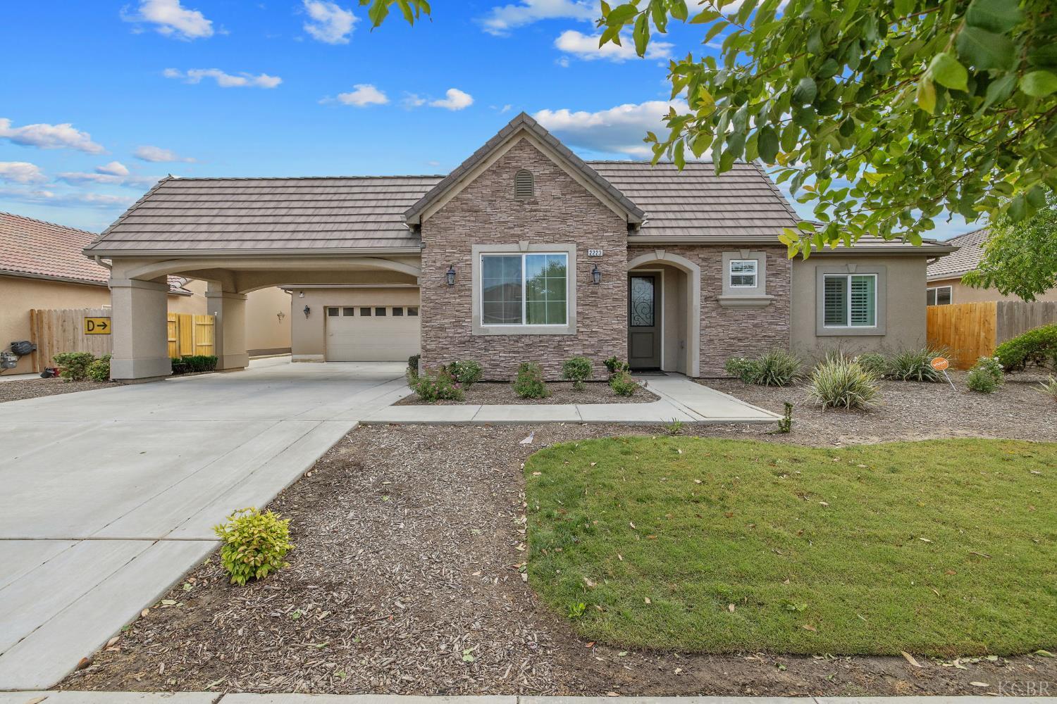 Welcome to this beautifully maintained former model home, offering 2,219 square feet of thoughtfully designed living space. This spacious residence features 3 bedrooms plus a versatile bonus room- perfect for a home office, gym, or guest space- and 2 full bathrooms. The primary suite is a true retreat complete with a walk-in closet and a luxurious ensuite bathroom featuring both a walk-in shower and a relaxing soaking tub. The open concept kitchen which overlooks the living room and dining room, is the true heart of the home. The dining room is complete with French doors leading out to the spacious backyard, perfect for entertaining! Additional highlights include an attached carport, a two-car garage, a beautiful courtyard, and a layout that blends functionality with comfort.
