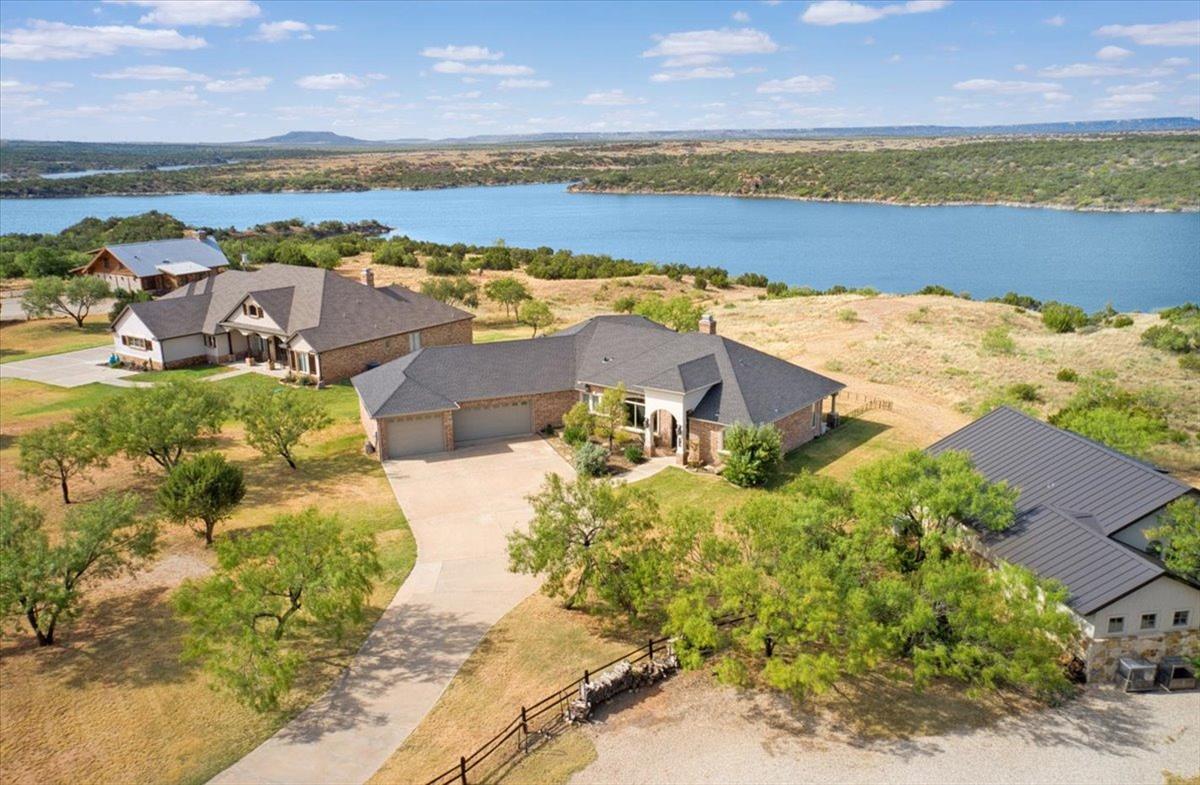 Stunning custom built one owner home.This lakefront home has incredible views of the lake as well as Flat Top Mountain.4366 sf under roof which includes a 1339 sf oversized 2 car garage and boat garage.  Huge back patio with multiple gathering areas, fireplace and outdoor kitchen.Large custom iron doors welcome you into the home which has been recently updated with luxury vinyl plank throughout living, kitchen and utility.Carpet only in bedrooms.  Second living area serves as a swing room for extra sleeping area/kid's den.Large open kitchen perfect for entertaining.Tons of storage,built in ice maker, beautiful granite,pantry and great island as well as new dishwasher&refrigerator Each room has large windows with fabulous lake views.Custom window coverings throughout.Large master closet serves as a safe room.Stairs to the lake as well as a landing have already been built.Access to Northridge private boat ramp.VRBO's are allowed.Boat garage door is 12'X 9'X31 Owner financing with lg. dp