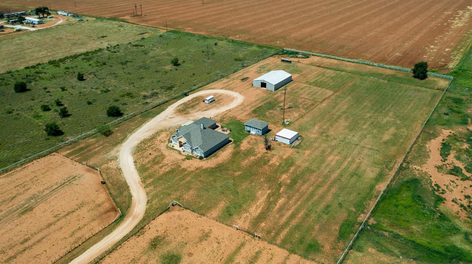 Your new Country Home is now on the Market. Located on just over 10 acres, this fully fenced with pipe fence and gate has all the amenities you want: 3 large horse pastures, a caliche driveway, 2 wells, 8 stall barn with tackroom, a saddle area, breeding stocks on re-enforced concrete slab. Plenty of room to easily add an arena. There are 2 concrete slabs in the front pasture with easy access to electricity and water. Inside the home you have a beautiful country 3 bed 2 bath home with granite counters throughout, plenty of storage, built-ins, tall ceilings, a full-functioning kitchen and spacious rooms. There is a back separate home that has its own septic tank as well. The back house is a Studio-style home with a shower, sink, toilet, AC window unit and cable access. This custom home is looking for THE country buyer. Only minutes from Lubbock. You are invited to your comfort, peace and life-style in your new home.