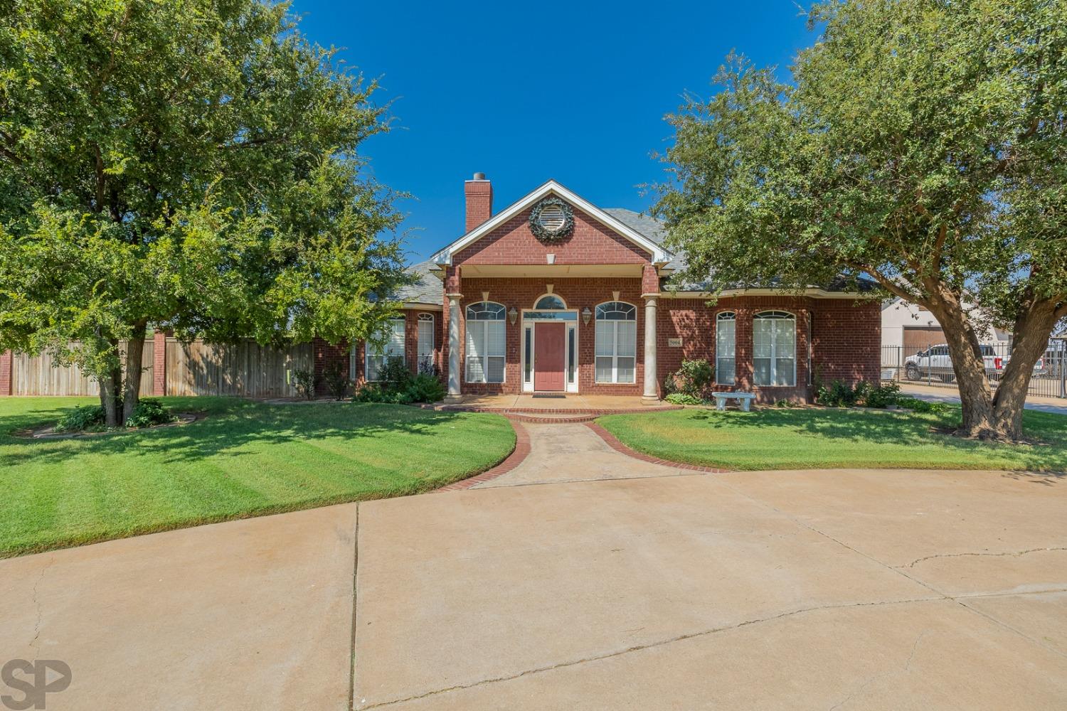 Welcome to this beautifully custom-designed, one-owner home in Llano Estates and Frenship ISD. The formal dining room greets you with hardwood floors, a wood-burning fireplace and natural light from the patio doors. The extensive kitchen features granite countertops, gas range, large island and doors to the exterior. You'll find plenty of use for the built-ins on either side of the living room fireplace. The spacious master suite includes his/her sinks, large closet and doors to the patio. Don't miss the basement wired for surround sound and upstairs bonus loft. Each bedroom features upper shelves and a built-in desk. Plantation shutters and crown molding throughout. Enjoy the central, covered patio with access from the dining room, living room and master bedroom. There's plenty of room in the 3-car garage with built-in work bench, cabinets and florescent shop lights. Exterior painted in September 2023. The corner lot provides more than 12,000 feet of fenced backyard!