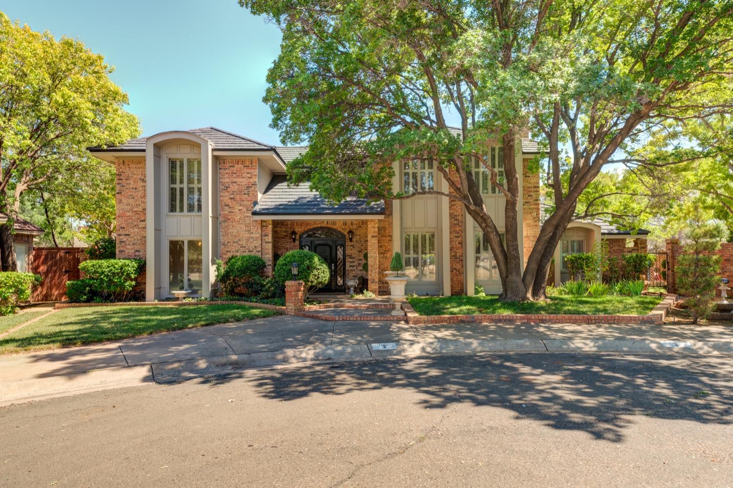 Designed by famed architect Deane Pierce, this home sits on TWO lots in the Whisperwood neighborhood. Only 5 minutes to Texas Tech and both main Hospitals make this the perfect location. 3 bedrooms, 3 full bathrooms, 2 living areas, 2 dining areas, a bonus/game room upstairs, 2 courtyards, and a 3 car garage. You don't feel like you're in West Texas walking into the oasis that the bonus lot offers. It has a secret garden feel. A well to irrigate everything, lush trees and landscape, brick wall fence, landscape lighting throughout, a water feature, and gazebo. And don't miss the Class 4 hail resistant Stone Coated Steel roof on the house. It is rare for a home like this to come available on the quiet Whisperwood Circle. So come see this property in person to appreciate it.