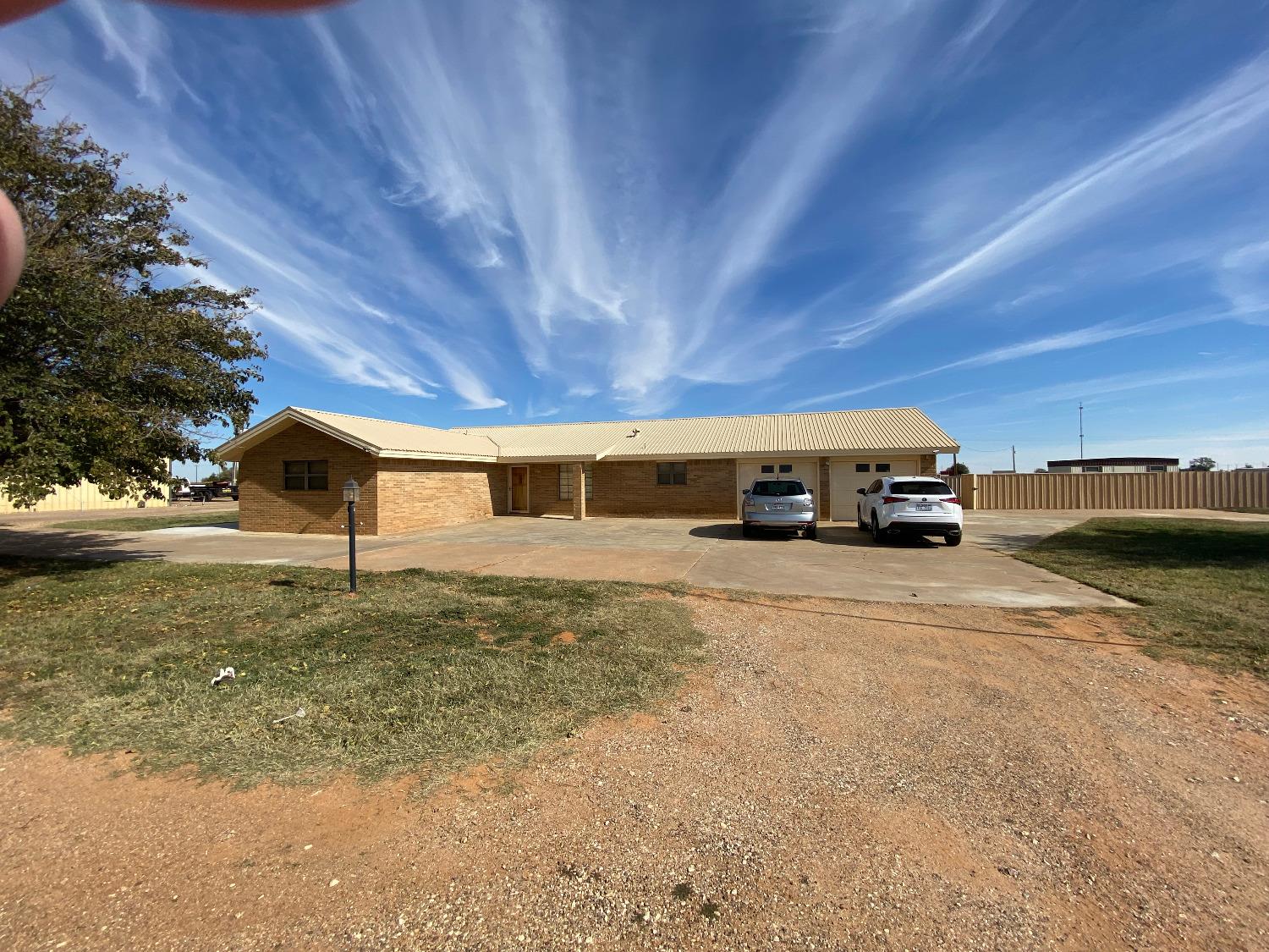 Ranch style 3/3/2 home with basement on 5.05 acres including 9,000 sq. ft of workshop area.Master BR closet is 20.5 X 8! Kitchen has double ovens, stainless appliances & tons of storage.2 living areas.  1st with gas fireplace & built-in gun cabinet and 2nd is 20 X 21 with plantation shutters and a massive brick hearth.Great storage throughout home. 2 water heaters & 2 HVAC systems. Metal roof with recent gutters.  Out buildings include a 7,200' shop with offices & 2 bathrooms, an 1,800' shop, animal shed/pens and well house.  The property is totally fenced.