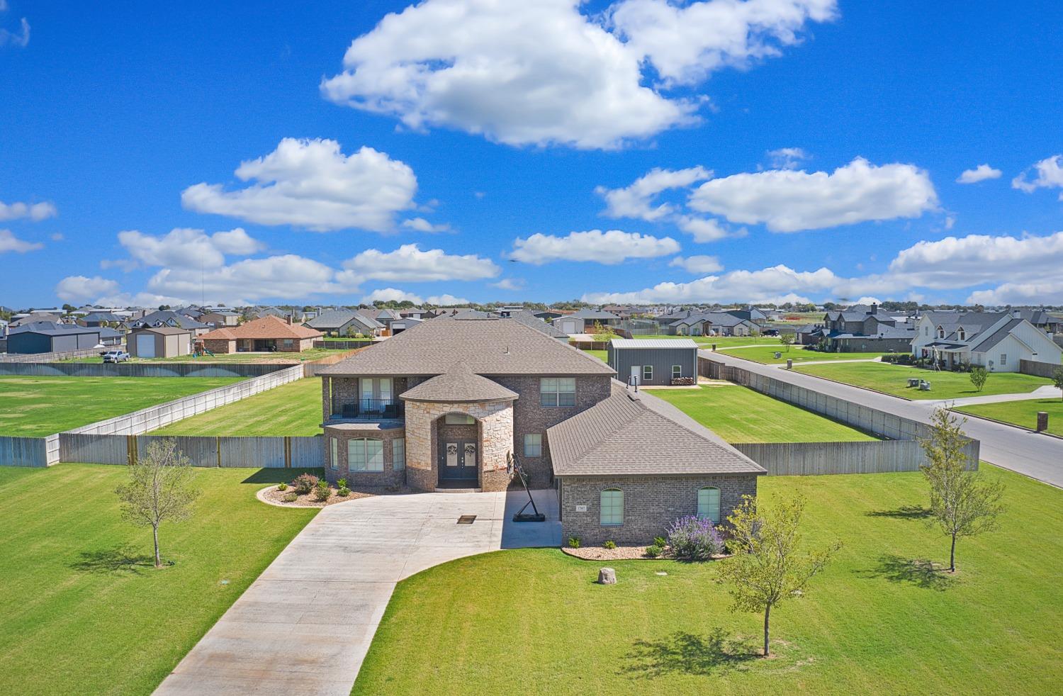 Incredible 6-bedroom, 4.5-bathroom haven nestled in prestigious Magnolia Estates on a sprawling 1-acre lot! Zoned to highly sought-after Cooper ISD, this home boasts a 3-car garage & a 25'x30' insulated shop, complete with electric, plumbing, & direct street access. You'll be welcomed by the grand entrance, showcasing a beautiful staircase, catwalk, & soaring cathedral ceilings that carry through to the spacious living room. Great open concept layout & ample space for entertaining! The expansive kitchen includes a large island, double ovens, a gas cooktop, & walk-in pantry. Custom countertops grace every surface in this home, featuring exquisite marble in the butler's pantry & laundry room, & stunning granite throughout. You'll love the luxurious master suite with his & hers vanities, an absolute dream closet, & a balcony. Great outdoor entertaining space on the large covered patio! Sprinkler system in front and back. Great opportunity to own your own piece of heaven in South Lubbock!