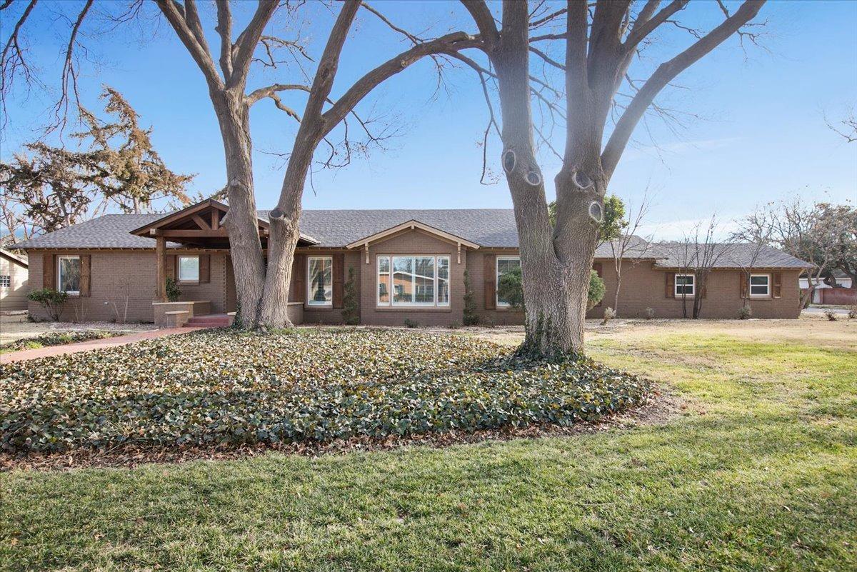 Located on premier block of the popular Rush neighborhood. If you need to be close to Texas Tech, LCU, downtown or the hospitals and like trees, you need to put this one on your list!  This 4 bedroom, 4 bath home has been updated from head to toe with high end finishes. Handscraped wood floors can be found throughout. The amazing kitchen includes beautiful quartz countertops, large island, stunning backsplash and stainless steel appliances. Family room offers high cathedral ceiling with spectacular beams. A second isolated master also makes a great studio/flex space. You will not only find many cosmetic updates, but also newer HVAC, plumbing and electrical. An 800 square foot back house comes complete with full kitchen, living, bedroom and bathroom, updated with modern luxuries and amenities. Spacious back yard with patio and firepit area. Plenty of space to add pool if desired. Call your favorite Realtor and go check it out today!