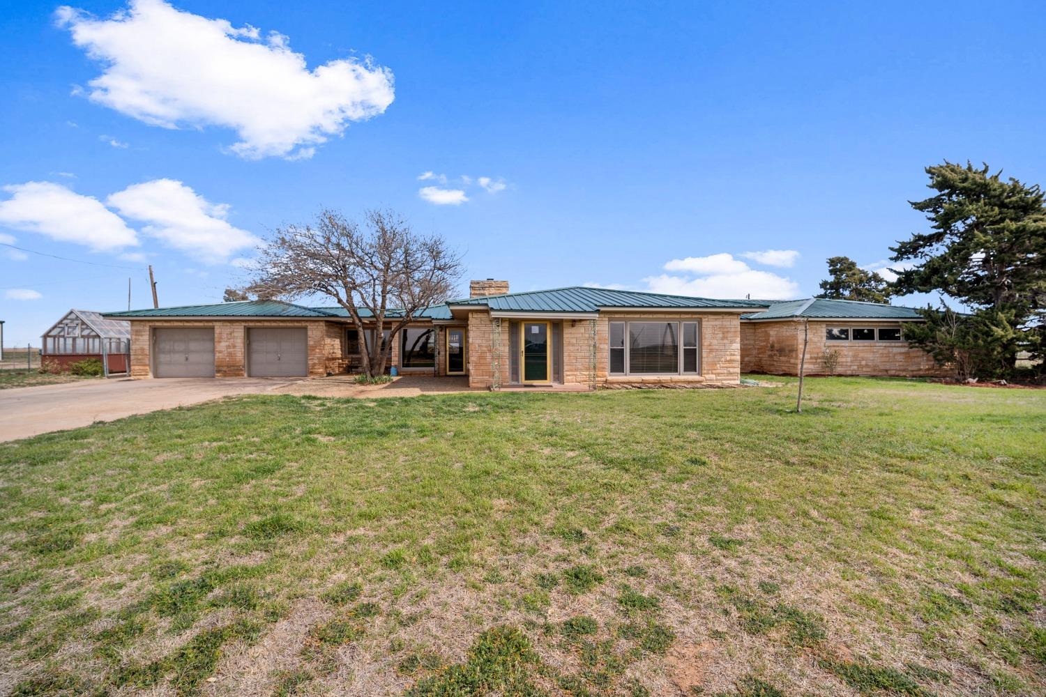 This beautiful ranch-style home is situated in a location that is far enough to enjoy the country, yet still close enough for convenience. With breathtaking views of sunrises over the cotton fields to the east and sunsets in the west, it's hard to imagine ever wanting to leave. The home boasts 3 spacious bedrooms, 3 extra-large bathrooms, 2 comfortable living areas, and a large kitchen. Living the country life on 5 acres couldn't be better, especially with the opportunity to bring your horses, goats, chickens, and other animals with you. You can even watch your very own catfish and blue gill bobbing for food in the pond, or try your hand at catch-and-release fishing. The 1/2 acre pond is fed by a well, and you can even enjoy swimming and paddle boating on it. When you're done playing in the water, you can relax on the cobblestone patio near the pond and enjoy a BBQ. Or maybe it's working in your very own greenhouse. Don't let this chance to experience West Texas living pass you by.
